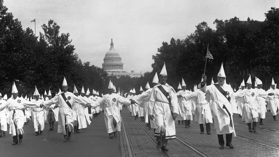 Ku Klux Klan members parade down Pennsylvania Avenue from the Capitol to the Treasury in Washington, D.C., on Aug. 8, 1925. Photo credit: Bettmann / Getty.