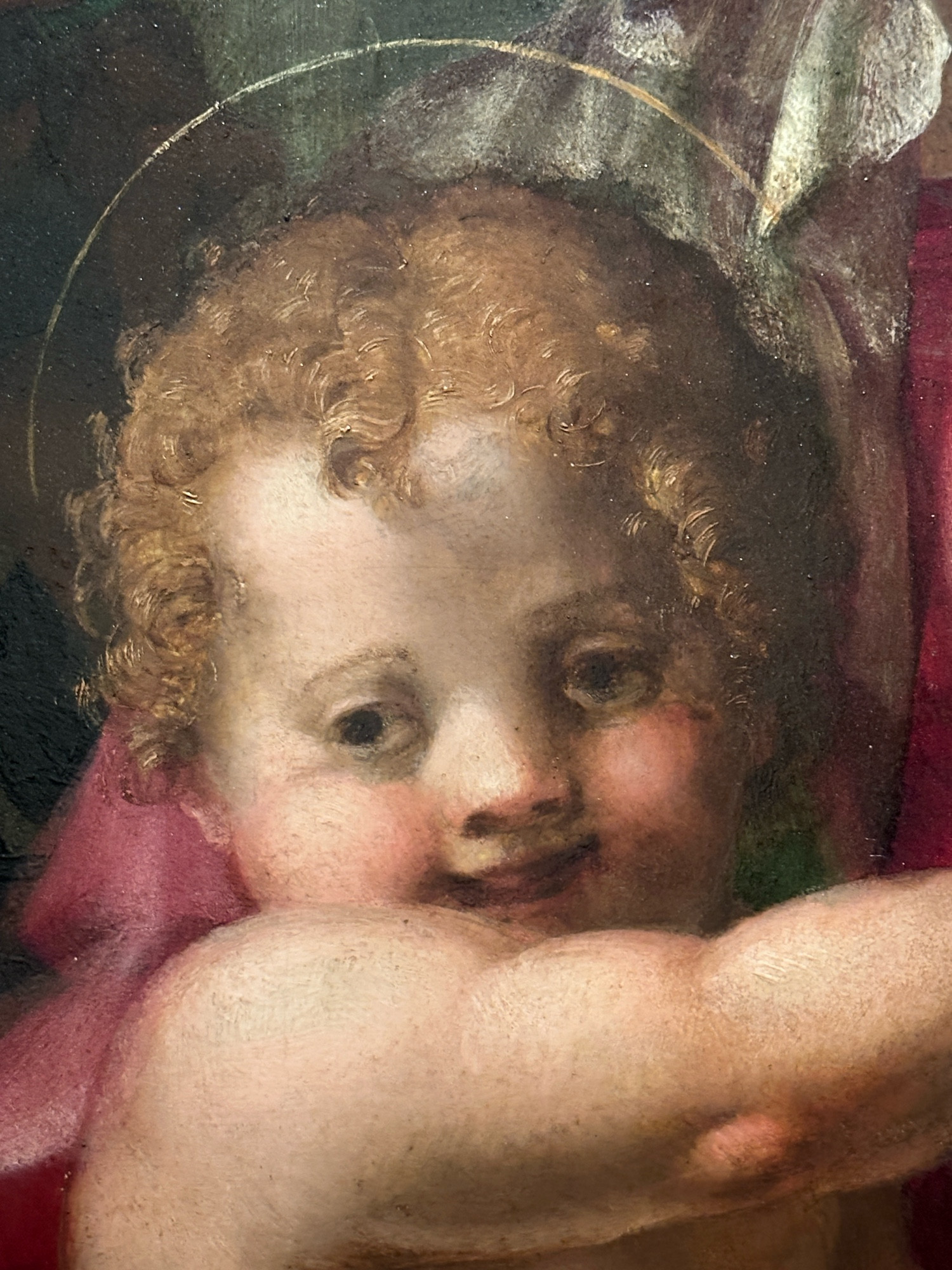 A painting of a blazed looking cherub. 