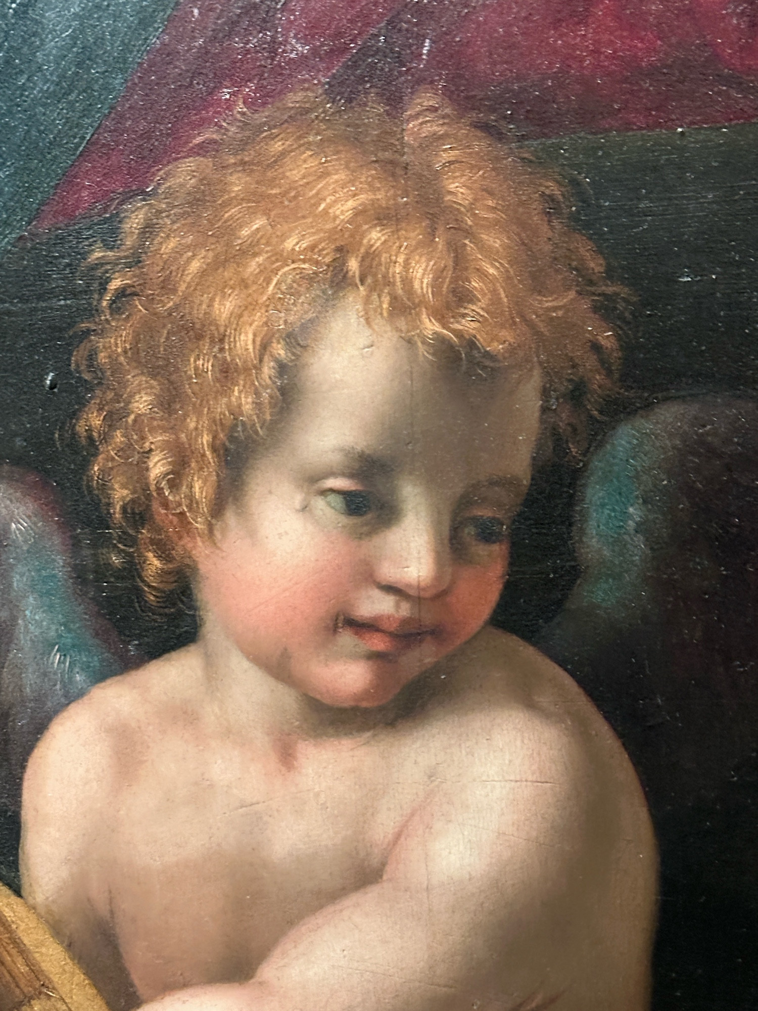 A painting of a cherub that can only be described as “not really all there”. 