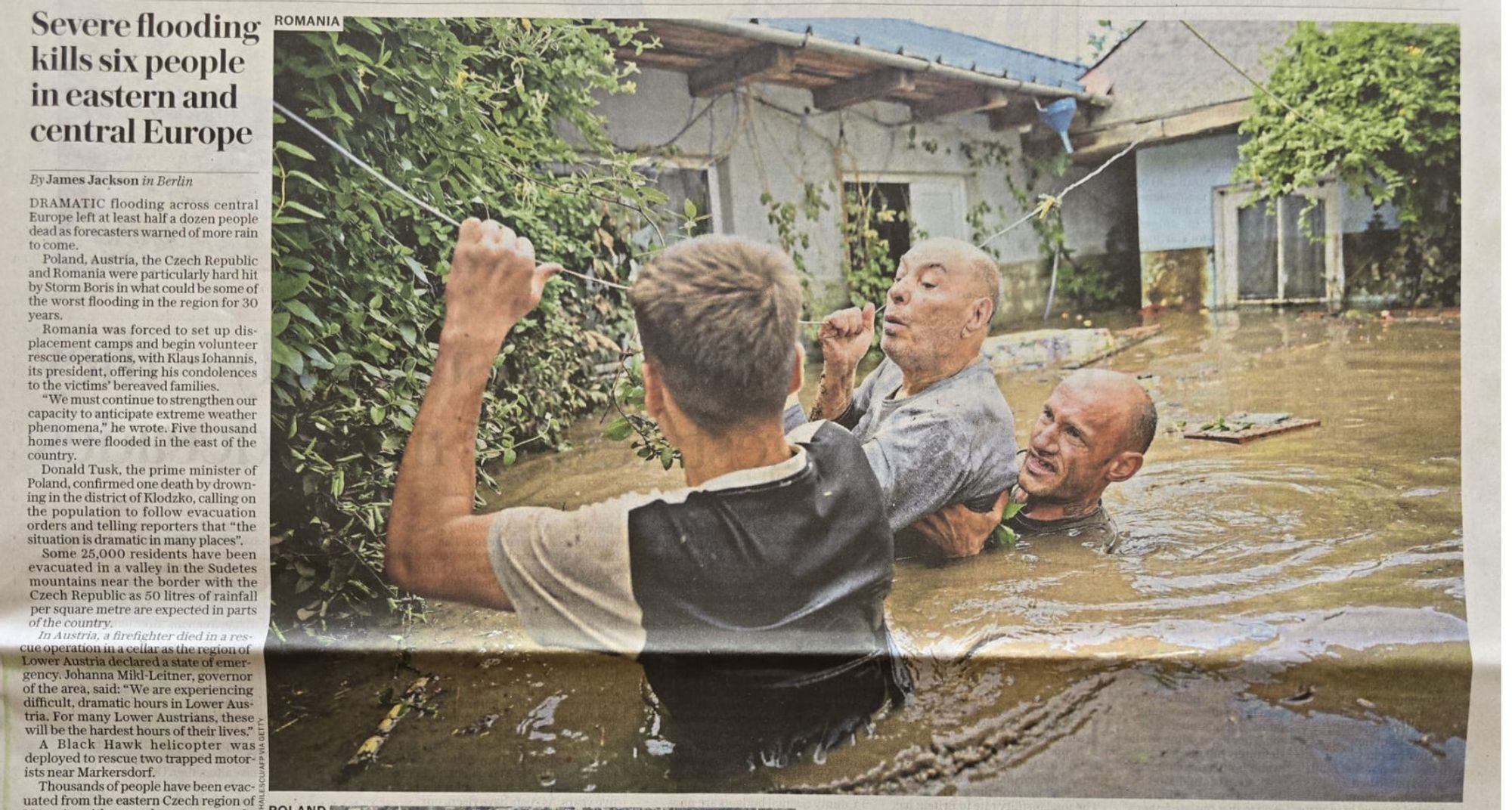 people wading up to their necks in water from the floods in Central and Eastern Europe.