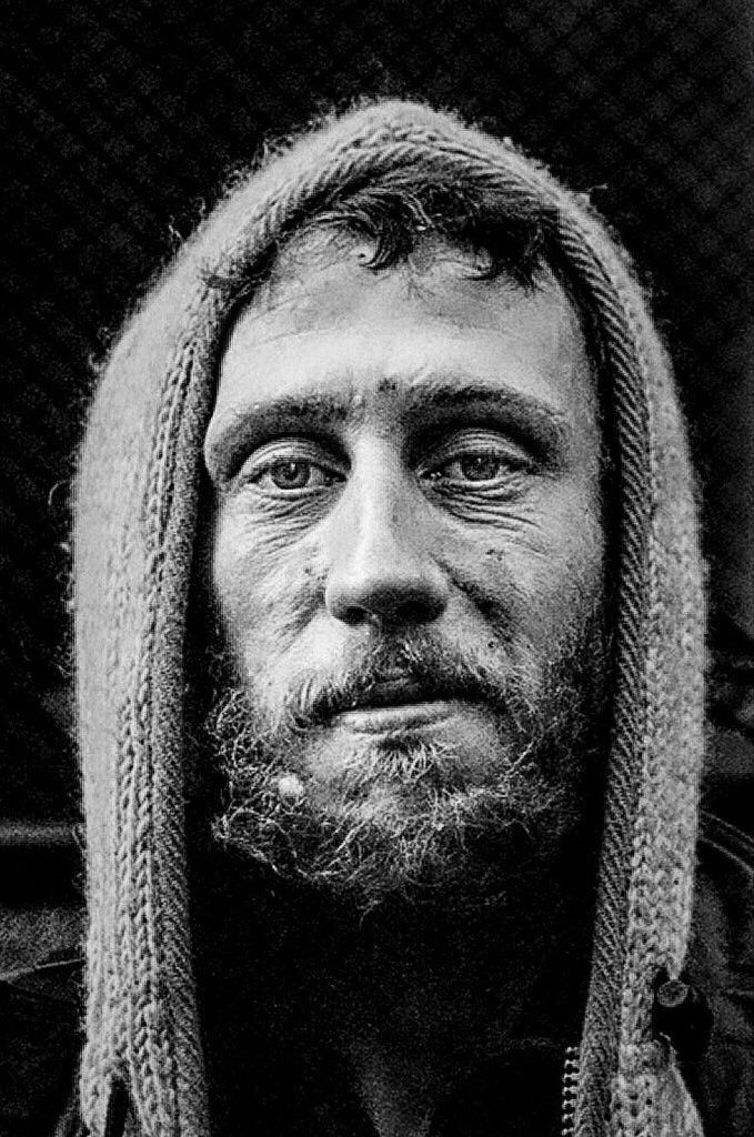 Black and white portrait of a man with a beard staring into the camera