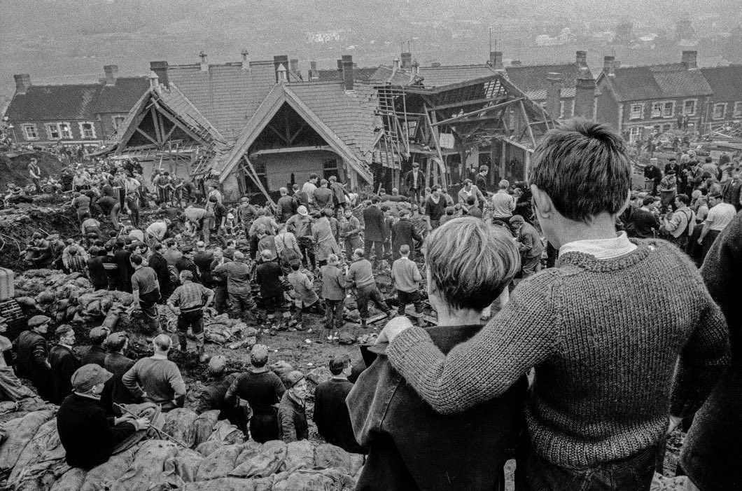 Black and white photo of two children looking down at the school in Aberfan