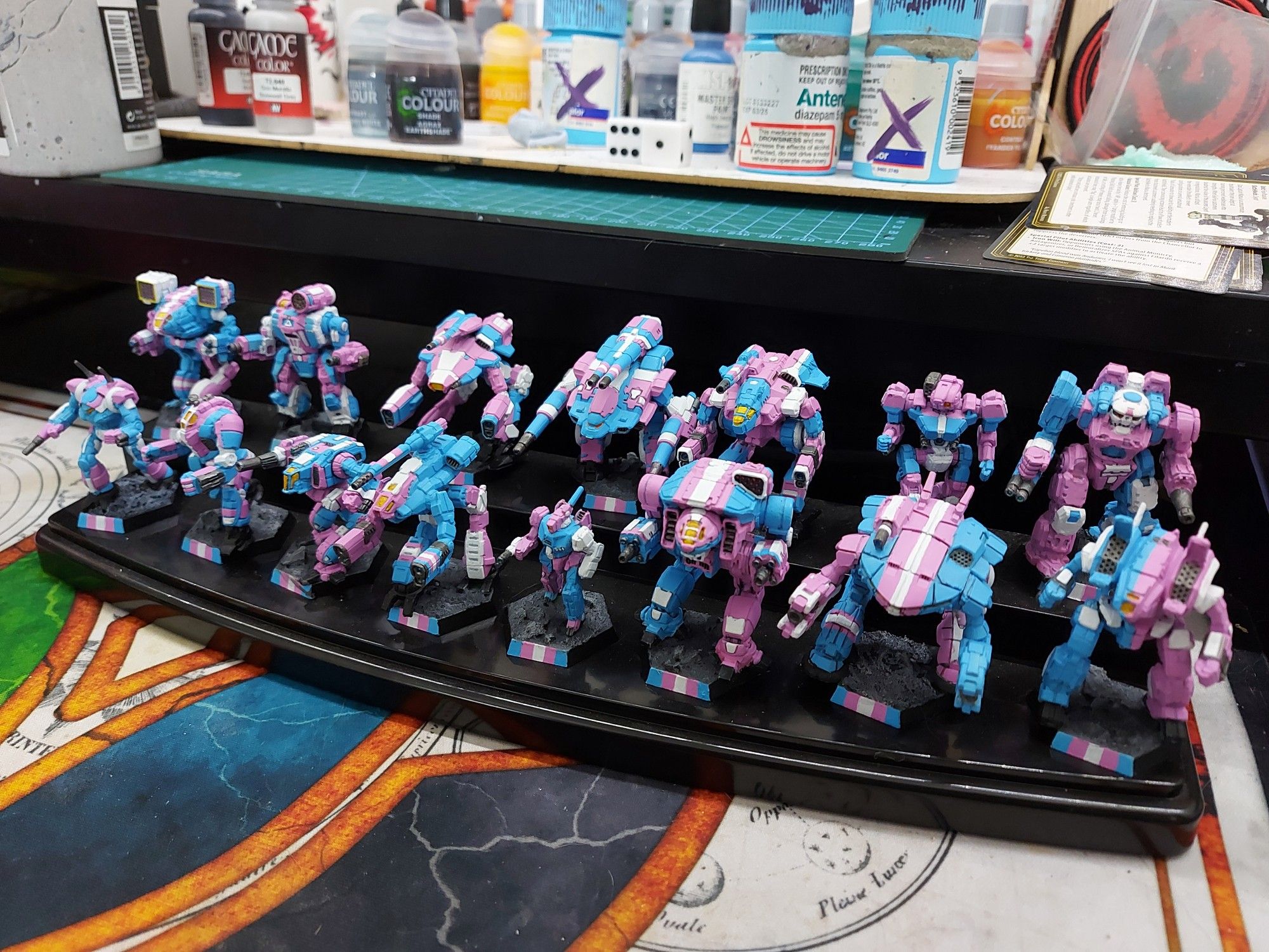 Battletech miniature mechs painted in trans pride colours