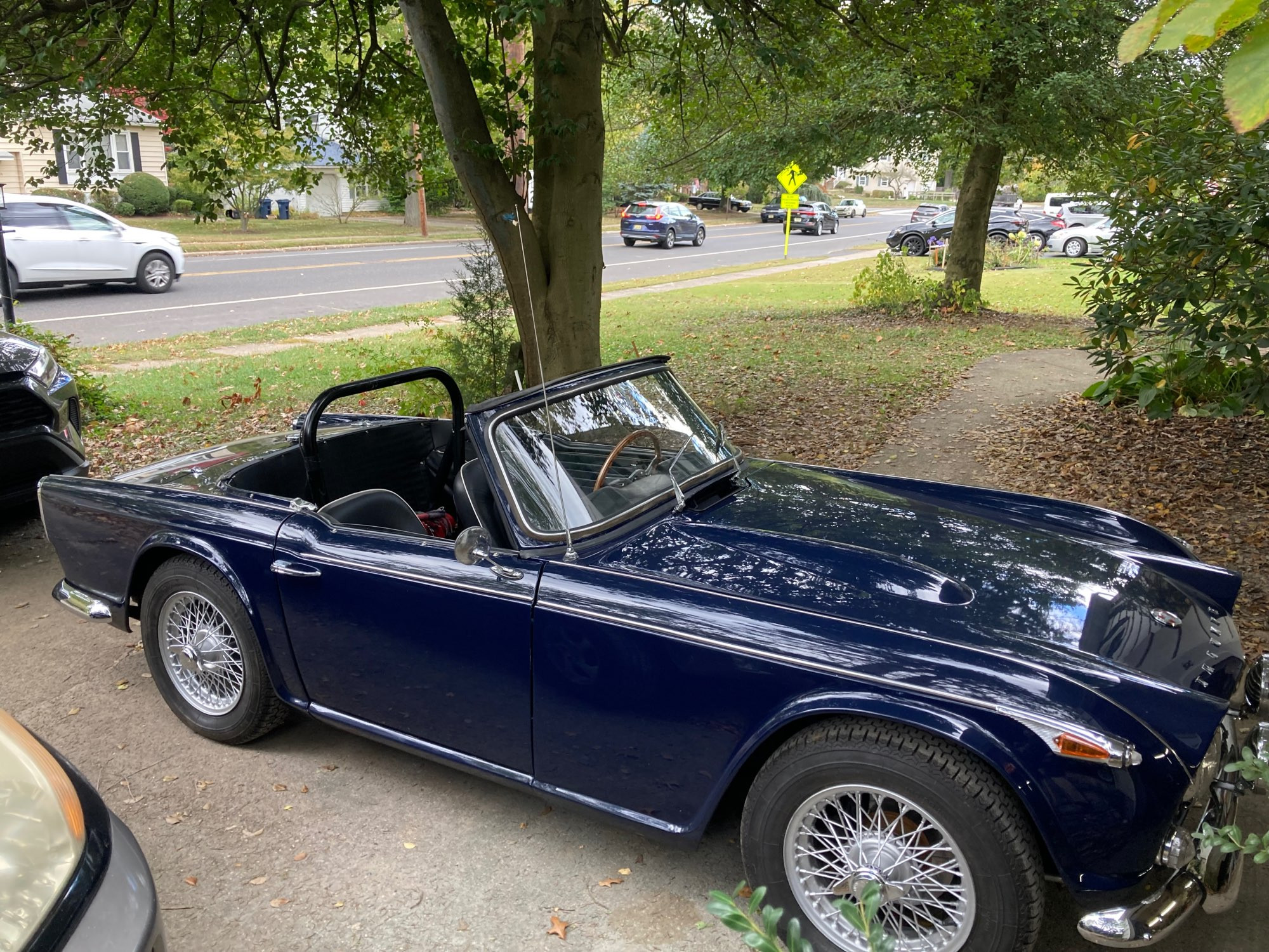 A photo of a 1966 Triumph TR4A in Royal Blue with wire wheels.