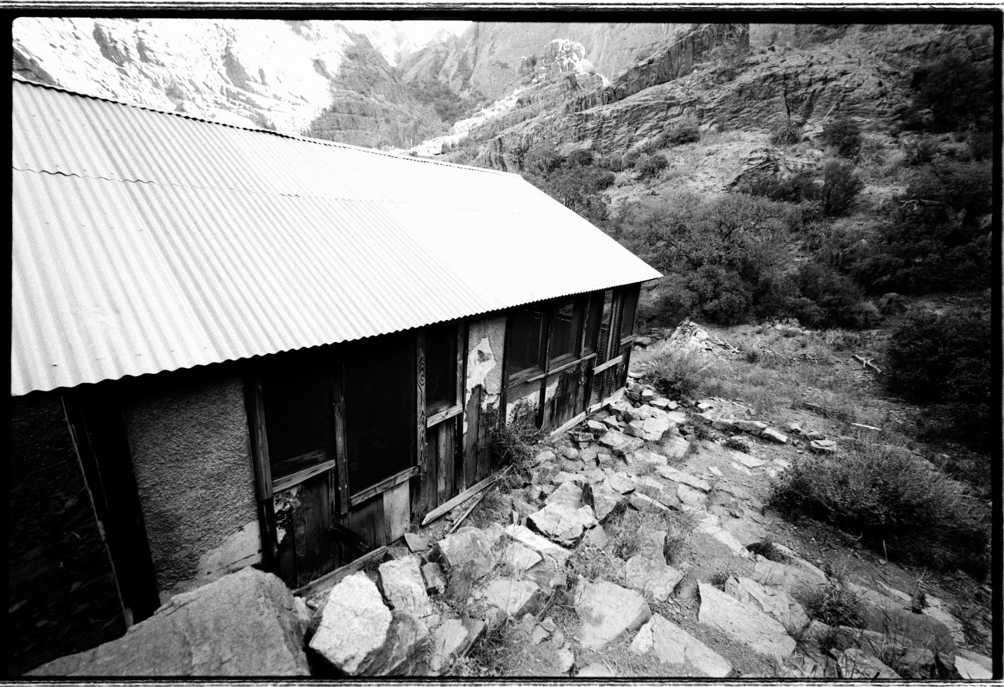 A black and white photo of the old Kitchen and Dining Hall at Boyd Sanitarium in Dripping Springs, NM. There were some large and beautiful tarantulas running around here. This building is obviously abandoned, but stands in pretty good shape - especially the roof. Part of the Organ Mointains-Desert Peaks Natural Area outside Las Cruces, NM 