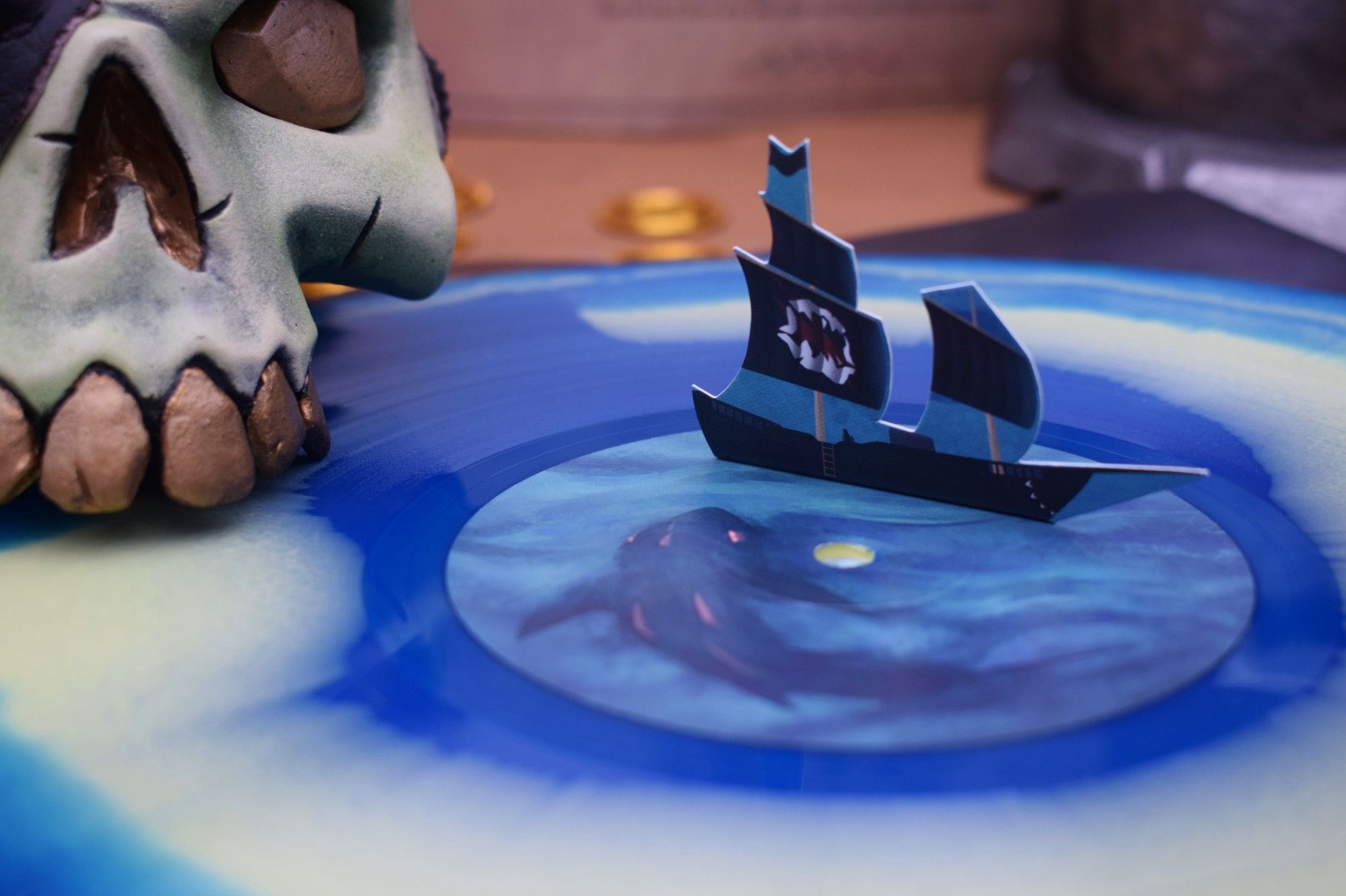 A close-up of a blue vinyl which features a small ship that would circle around its centre when being played.