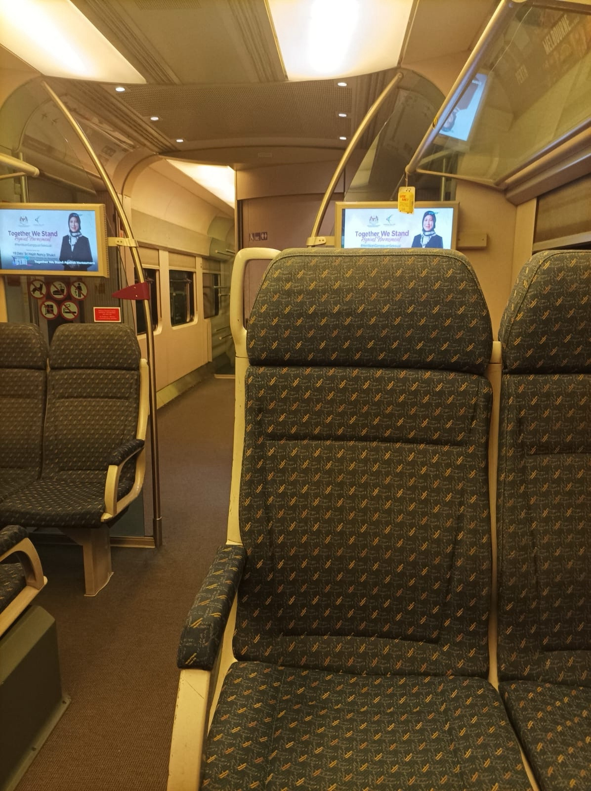 Train seats. Inside of a train in Malaysia with a bathroom stall.