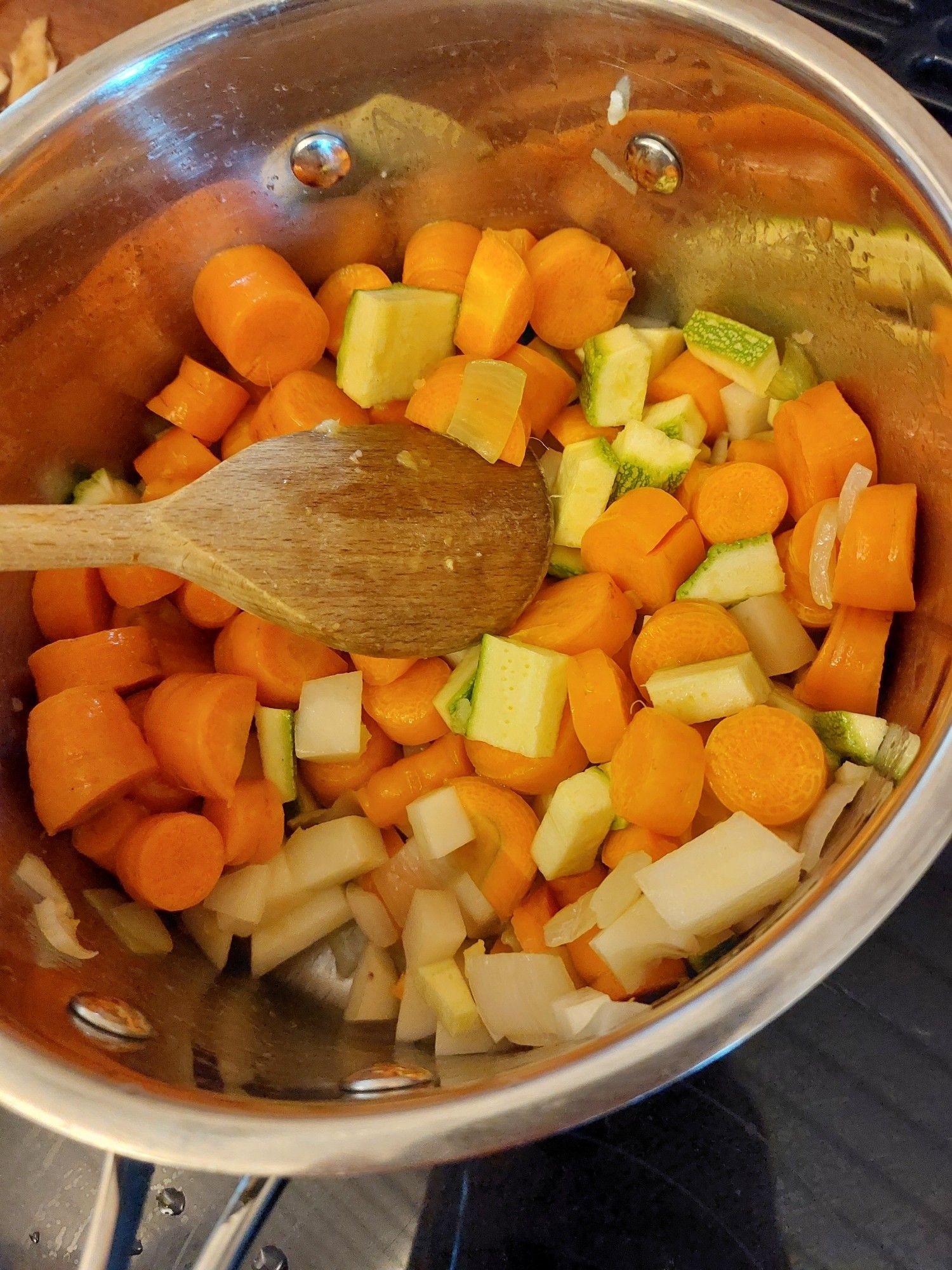 Pan, full of chunks of homegrown carrot, onion, courgette, potato and garlic