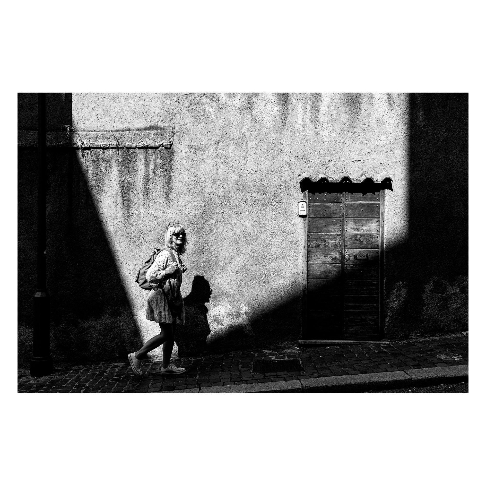 photo of a woman stepping in a corner of light
street of roma