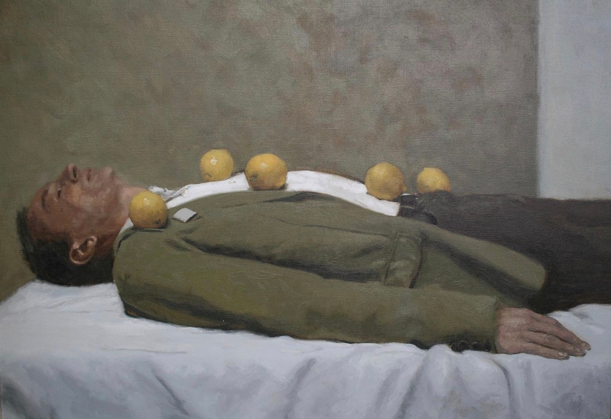 Painting by Rafel Bestard depicting a man dressed in a suit lying prone, arms at his side, with lemons resting on various points across his torso.