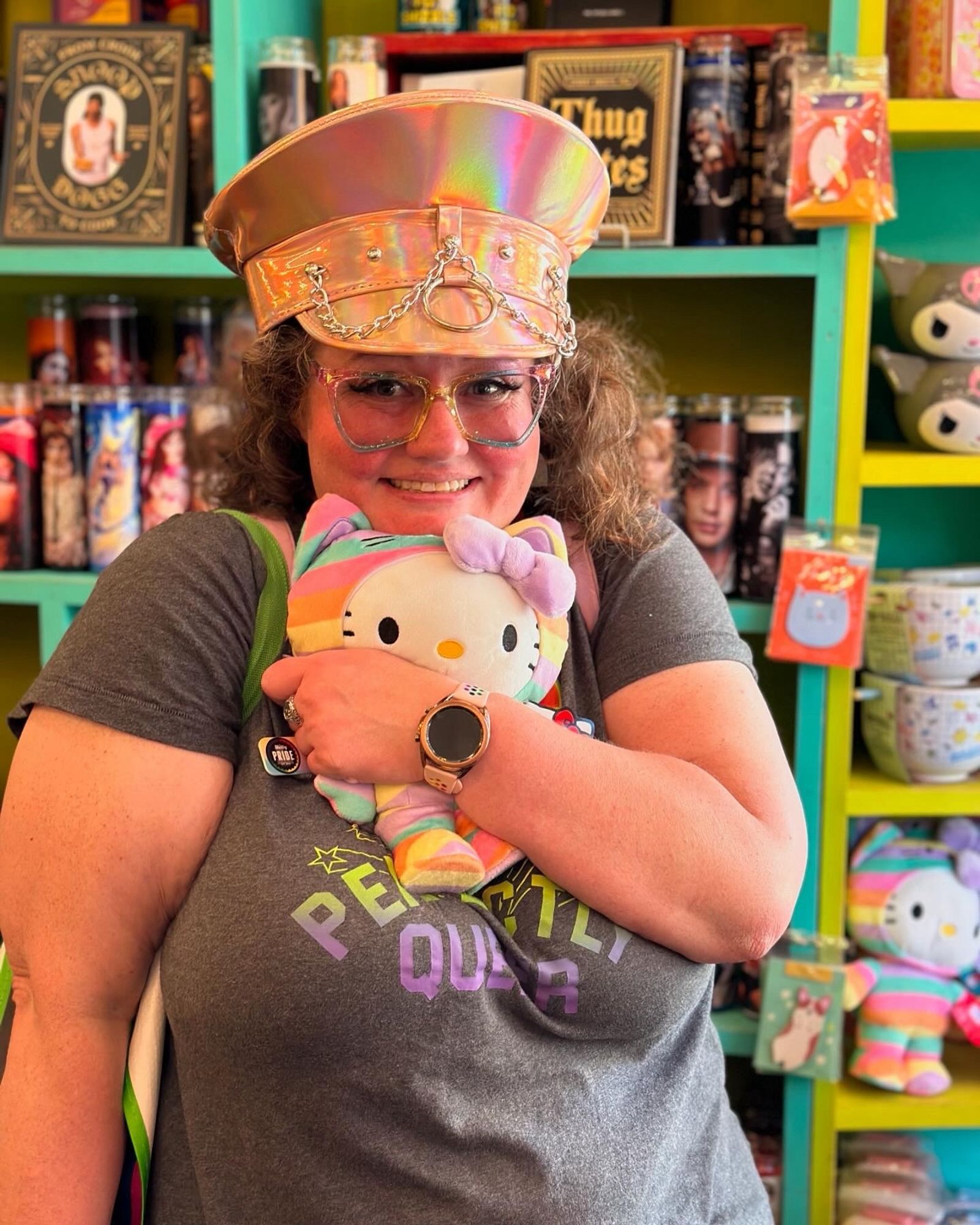 Photo of Melissa being adorable and holding a rainbow hello kitty plush