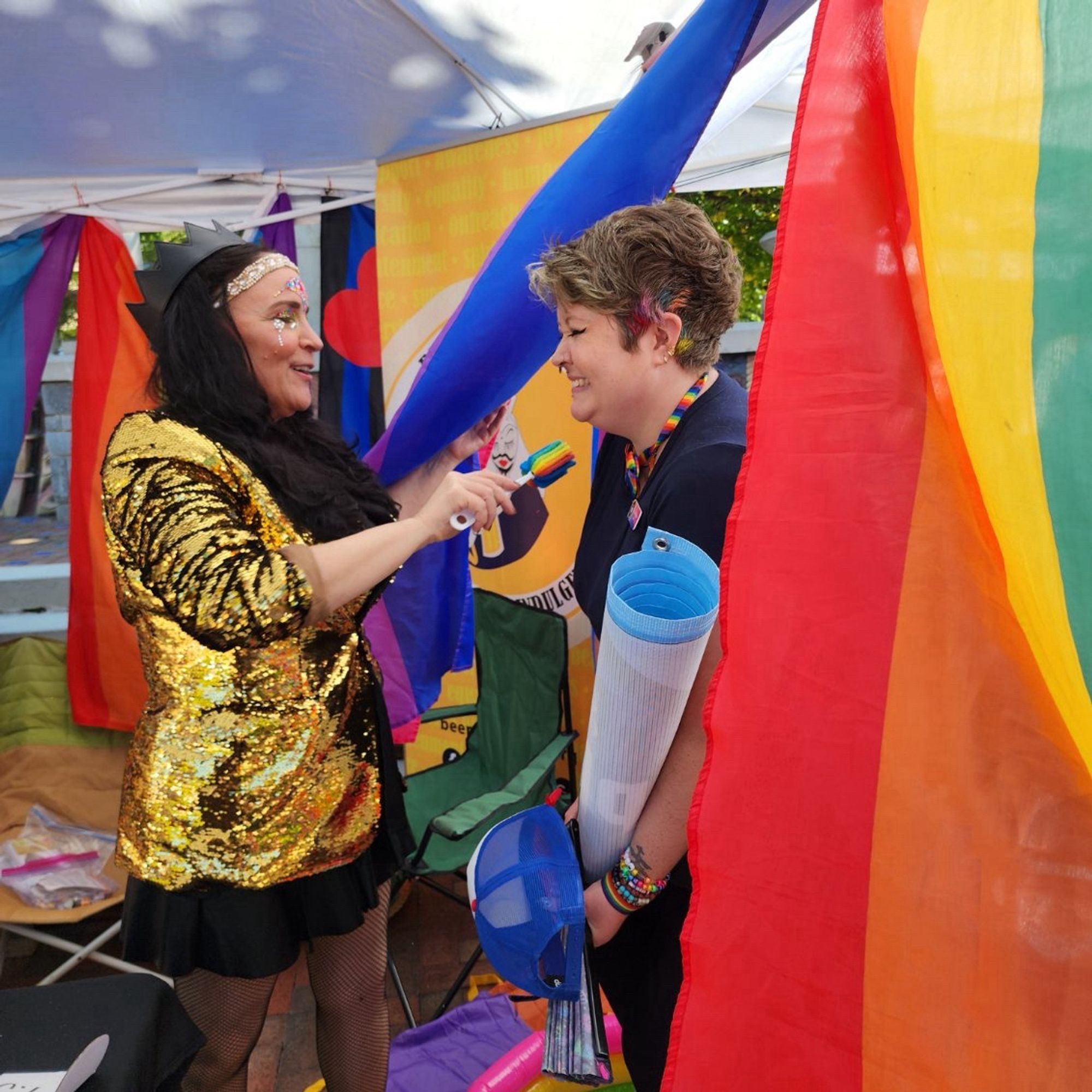 Photo of me and a lovely woman in drag giving me a glitter blessing