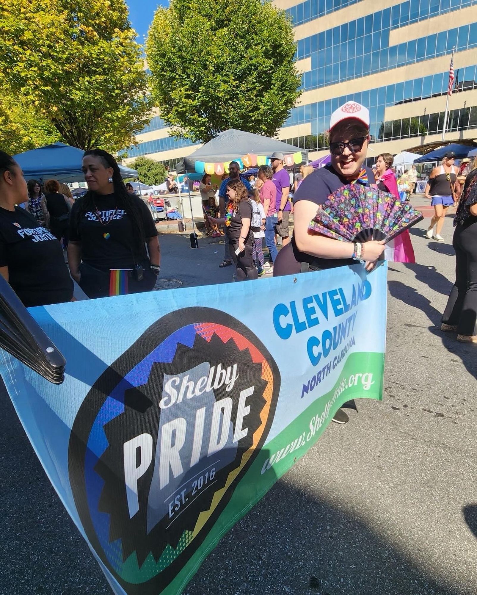 Photo of me carrying the Shelby Pride banner in the parade