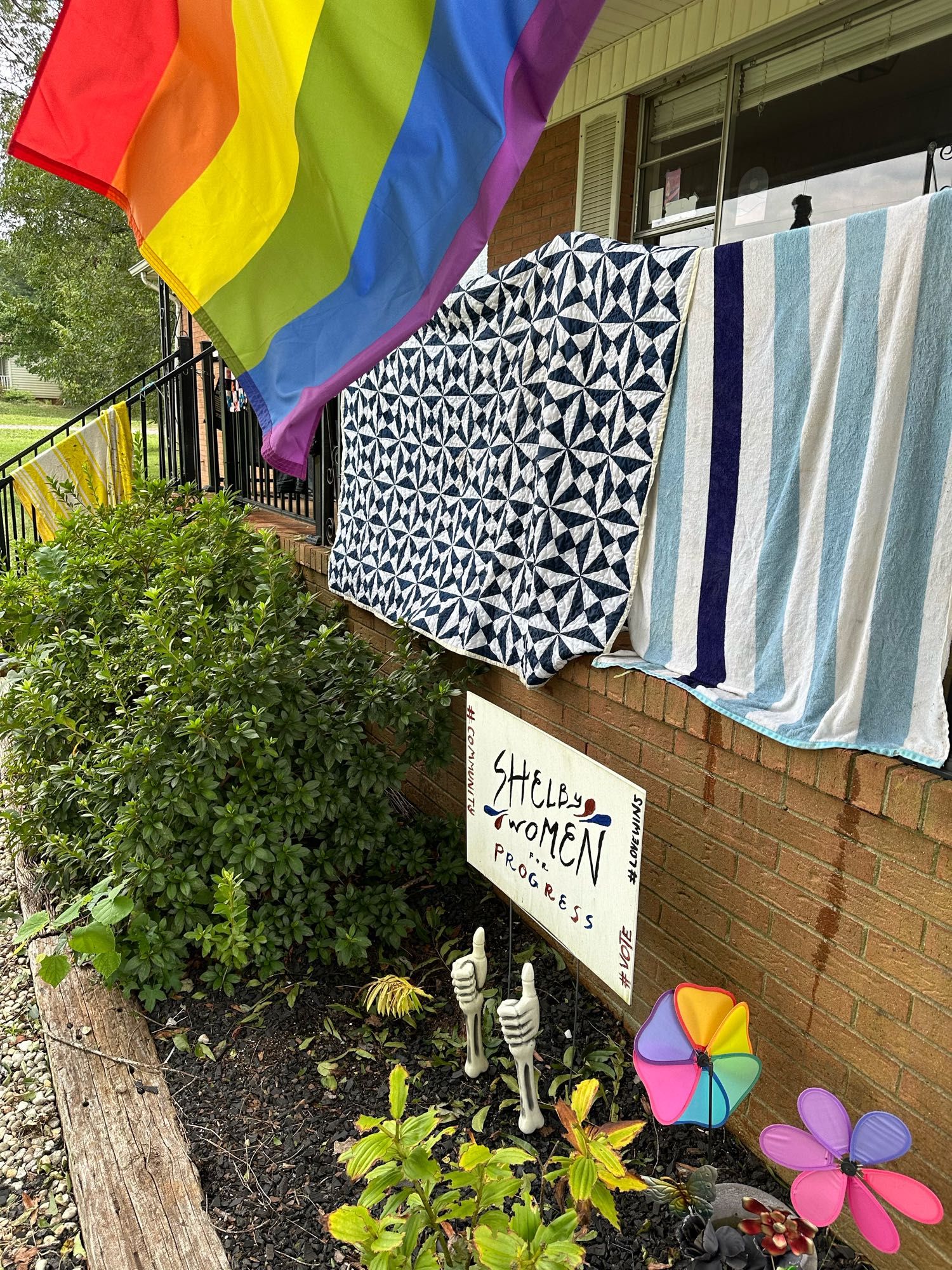 Wet towels and quilts hanging of then porch banner to dry out from the basement