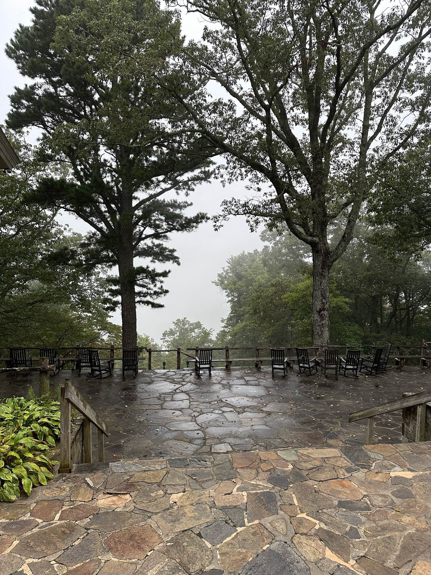 Porch view with rocky chairs and a foggy mountain