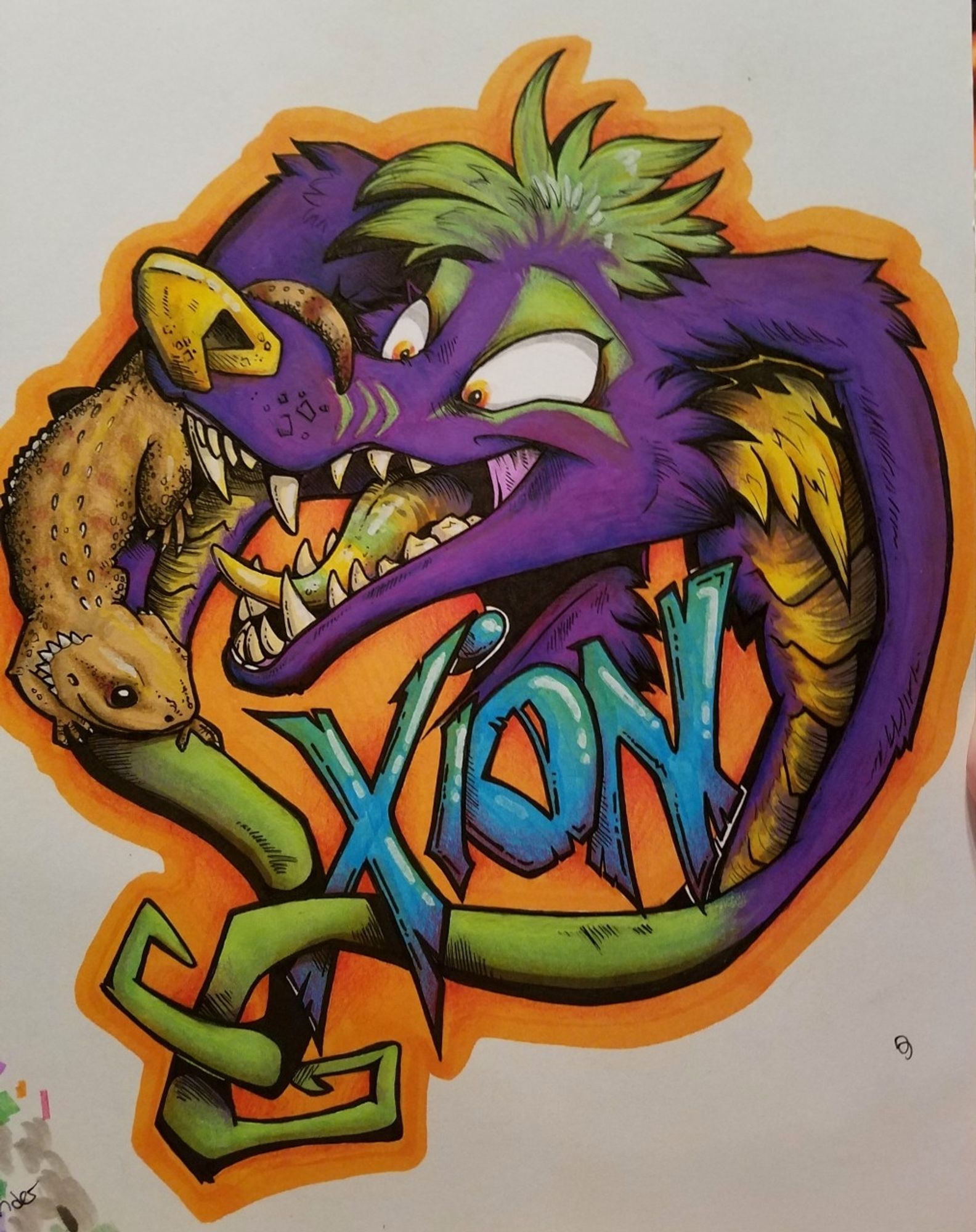 A purple & yellow crux with a bearded dragon friend. Badge reads "Xion"