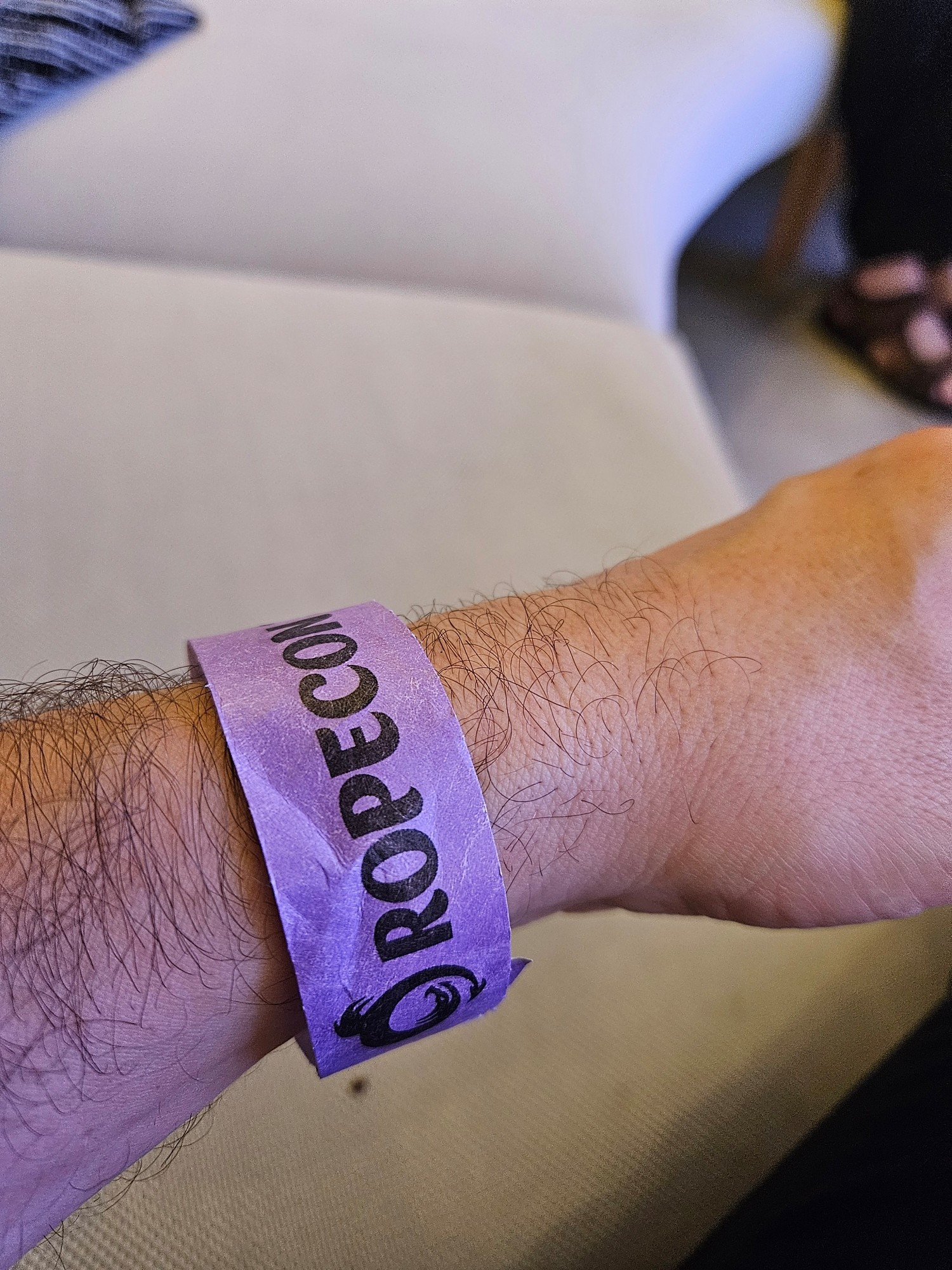 Wrist with Ropecon 2024 bracelet ticket