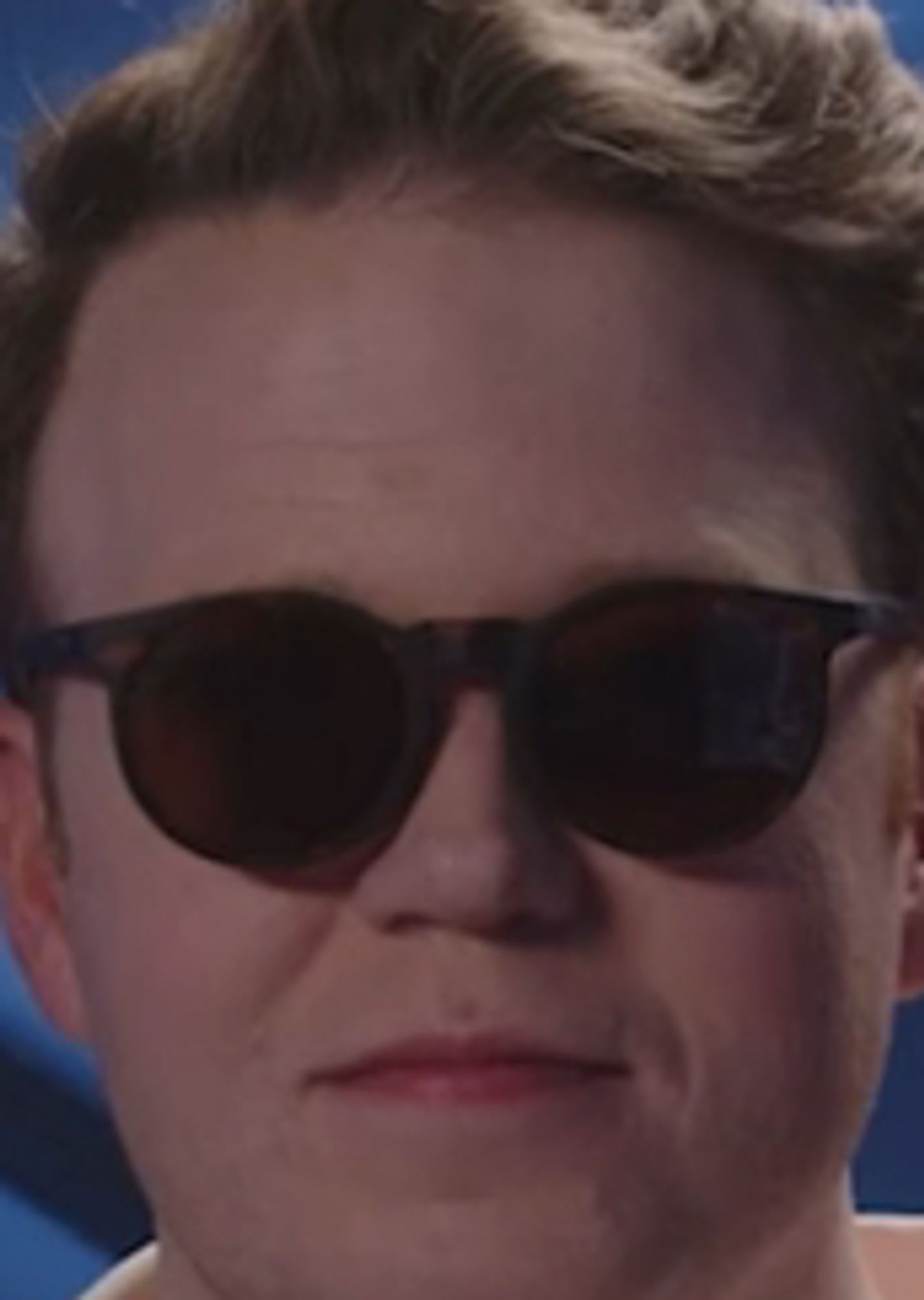 very close up image of brennan lee mulligan wearing round sunglasses that are too small for his face. he looks like a junior cop