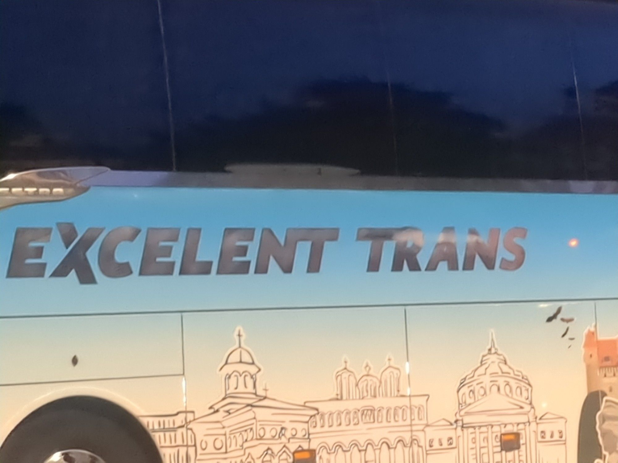 a bus saying "excelent trans" on its side