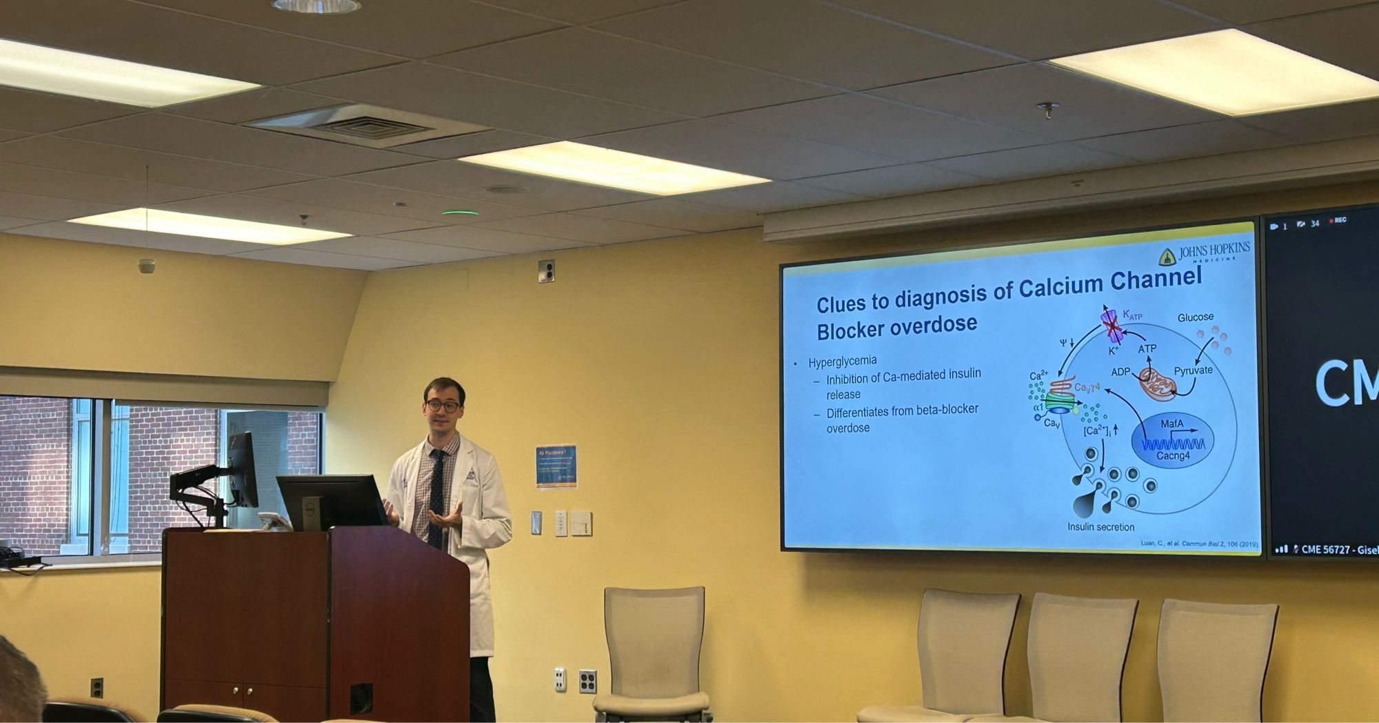 Guy in white coat showing a slide saying:

Clues to diagnosis of Calcium Channel
Blocker overdose
Glucose
Hyperglycemia
- Inhibition of Ca-mediated insulin
ADP.
Pyruvate
release
- Differentiates from beta-blocker overdose