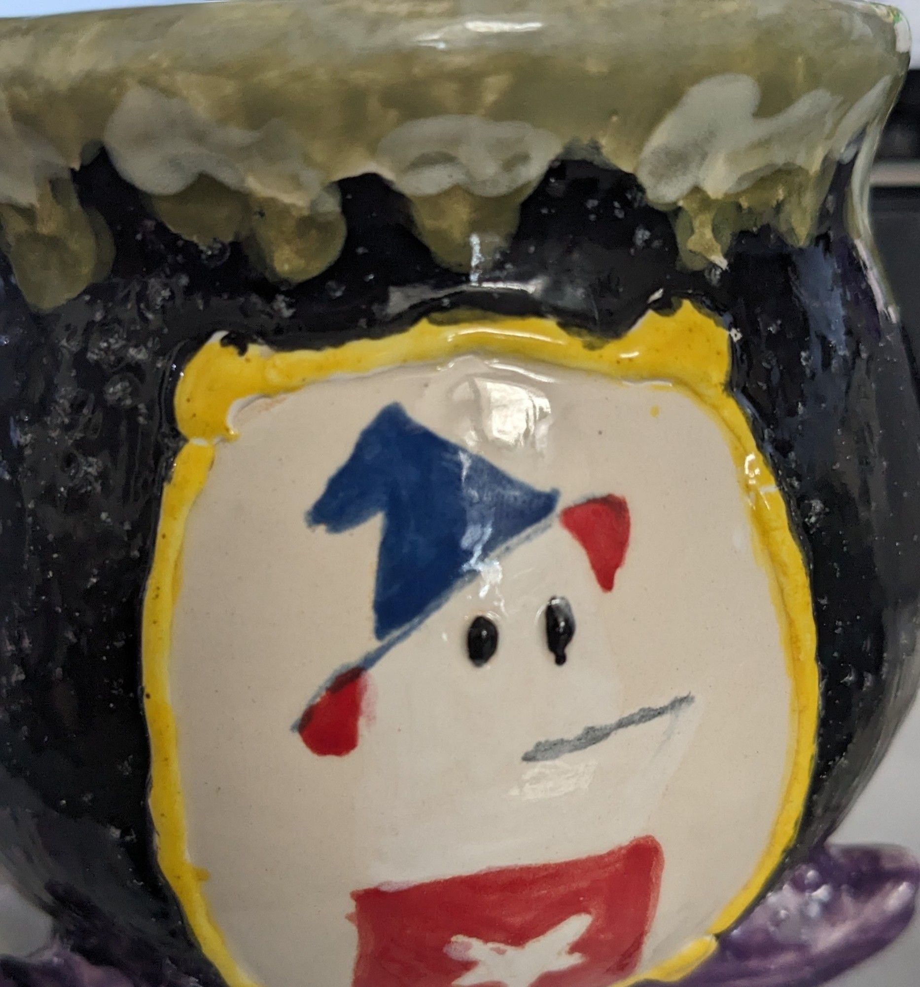 Mug I painted, looks like a cauldron with a vignette of homestar runner with a generic witch's hat.