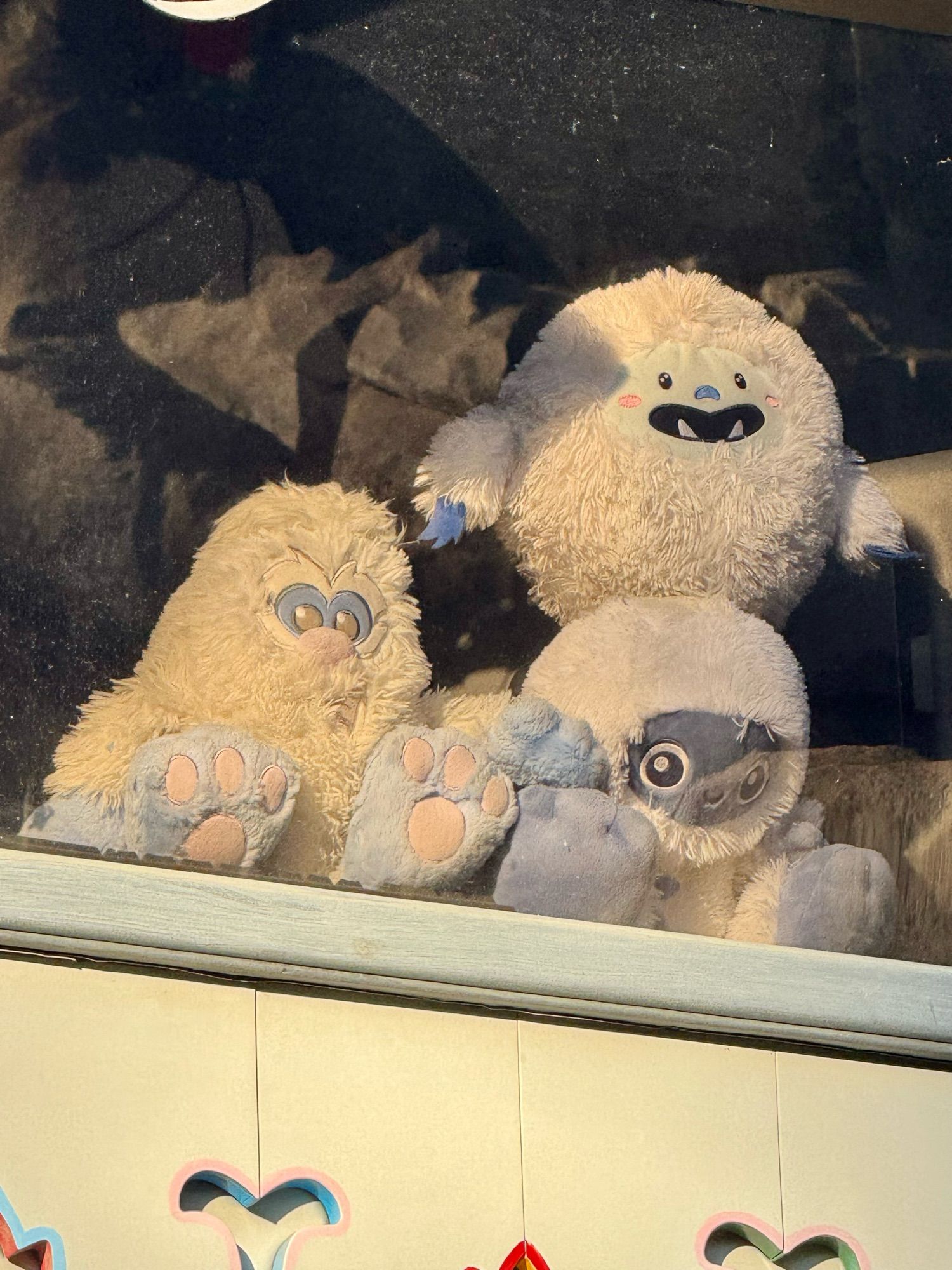 Three assorted Yeti plushes in the upper booth at Matterhorn in Disneyland