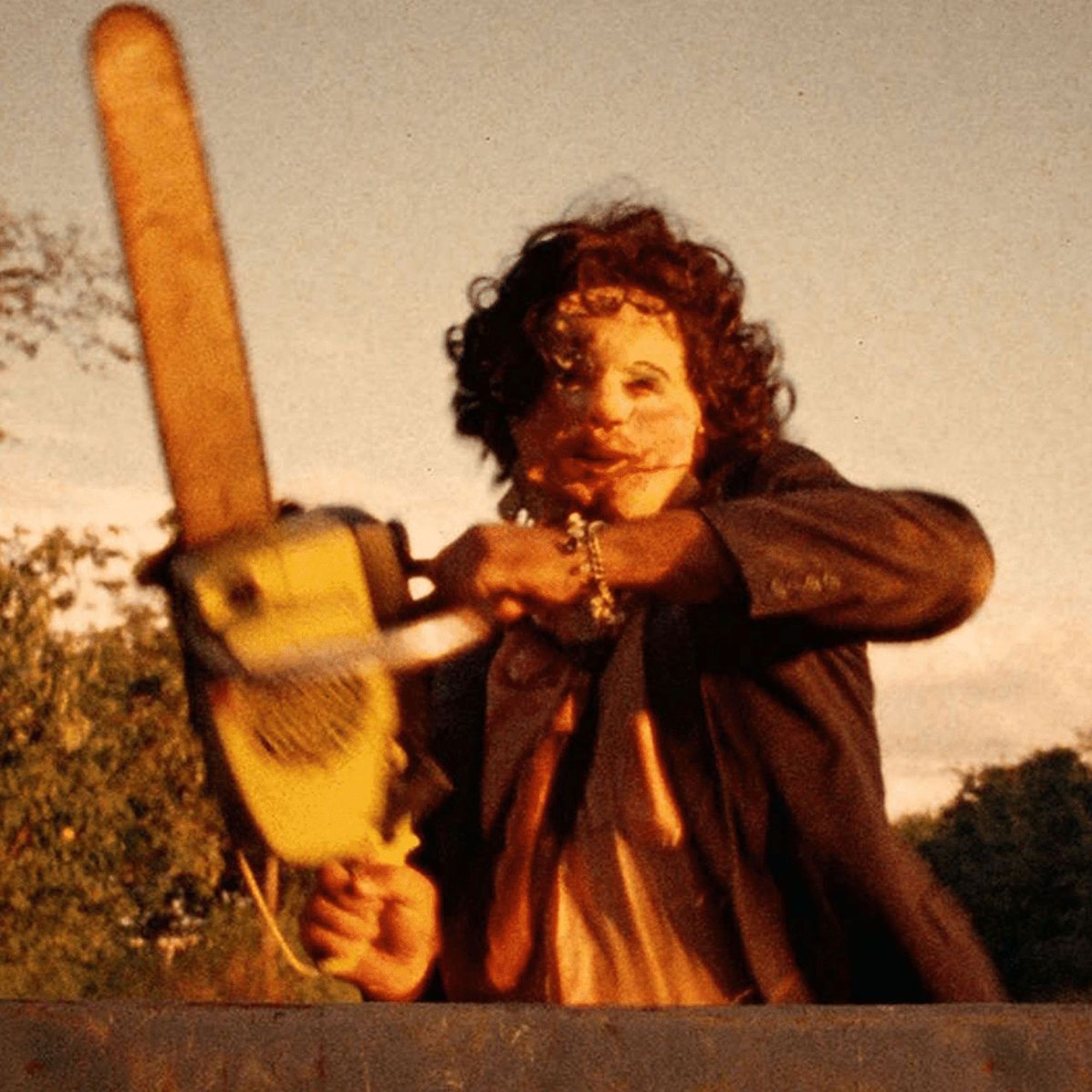 Leatherface from The Texas Chainsaw Massacre holding up a chainsaw