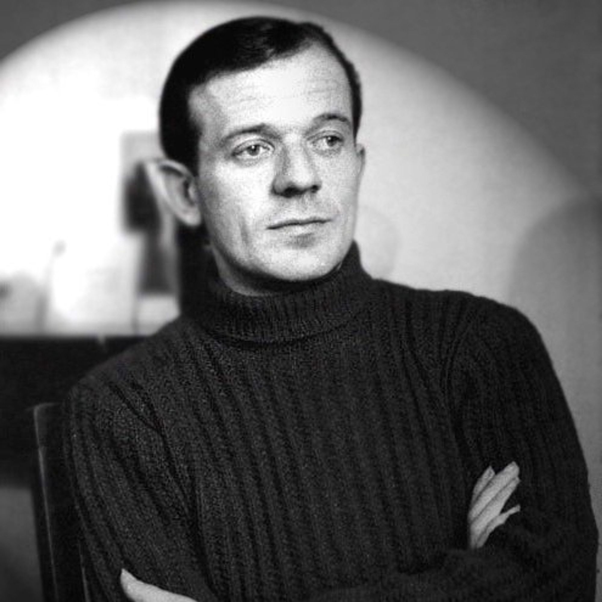 black and white photograph of Gilles Deleuze wearing a black turtleneck jumper