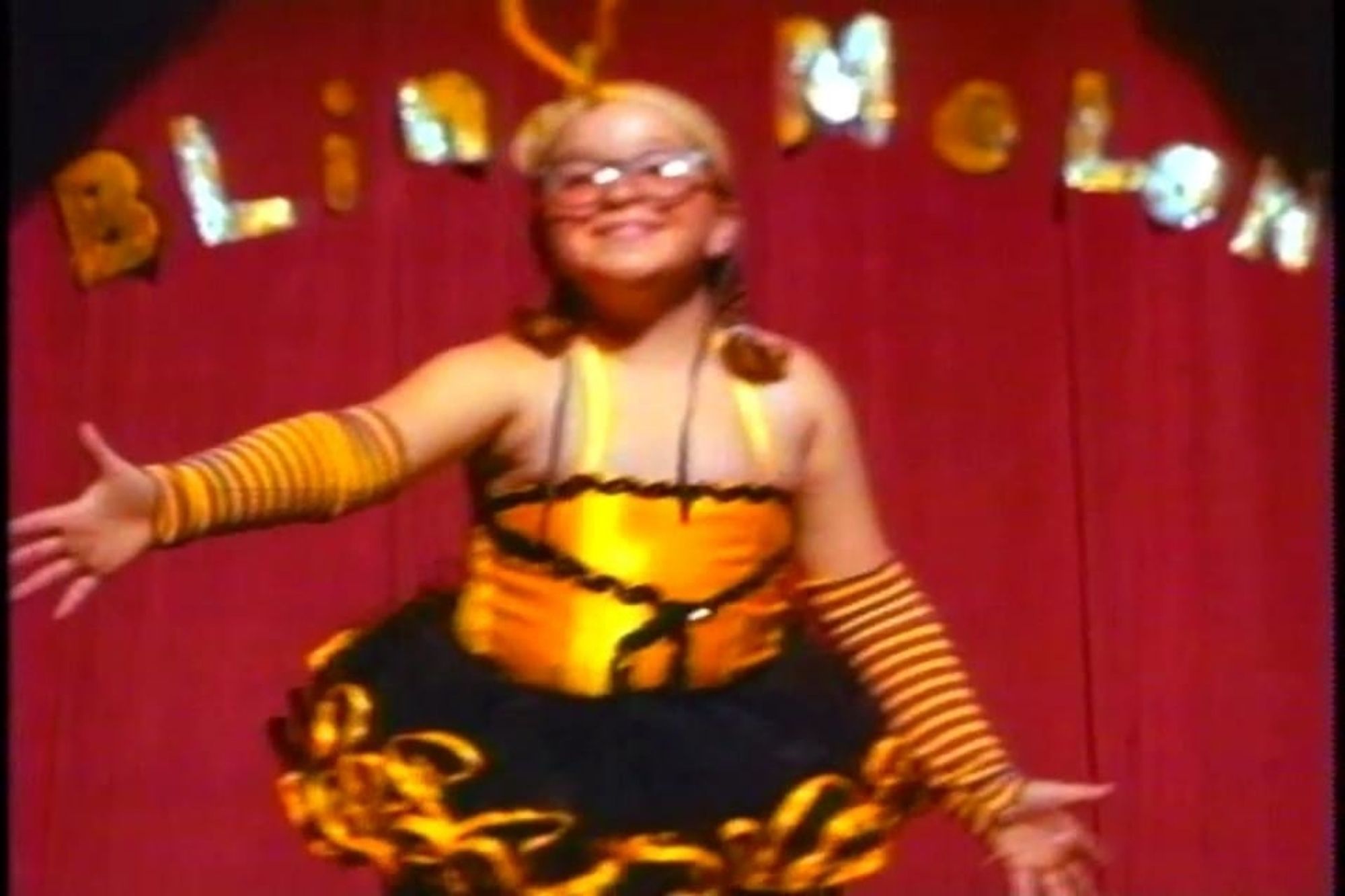 Screenshot of the music video for Blind Melon's "No Rain" music video, with a little girl dancing in a bee costume