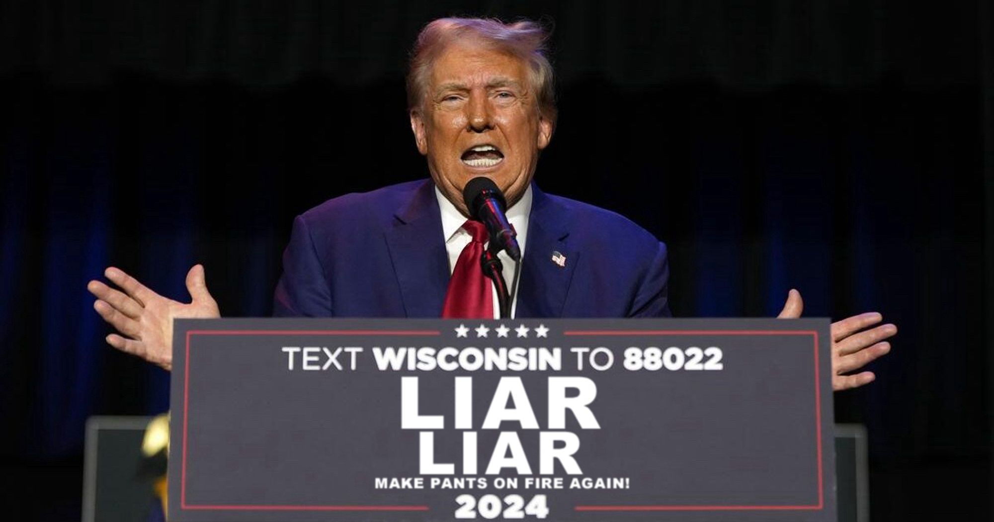 Twice impeached convicted felon and adjudicated rapist Donald J. Trump lying at a podium with a sign that, instead of “Trump Vance” reads “Liar Liar” with the slogan “Make Pants On Fire Again!”