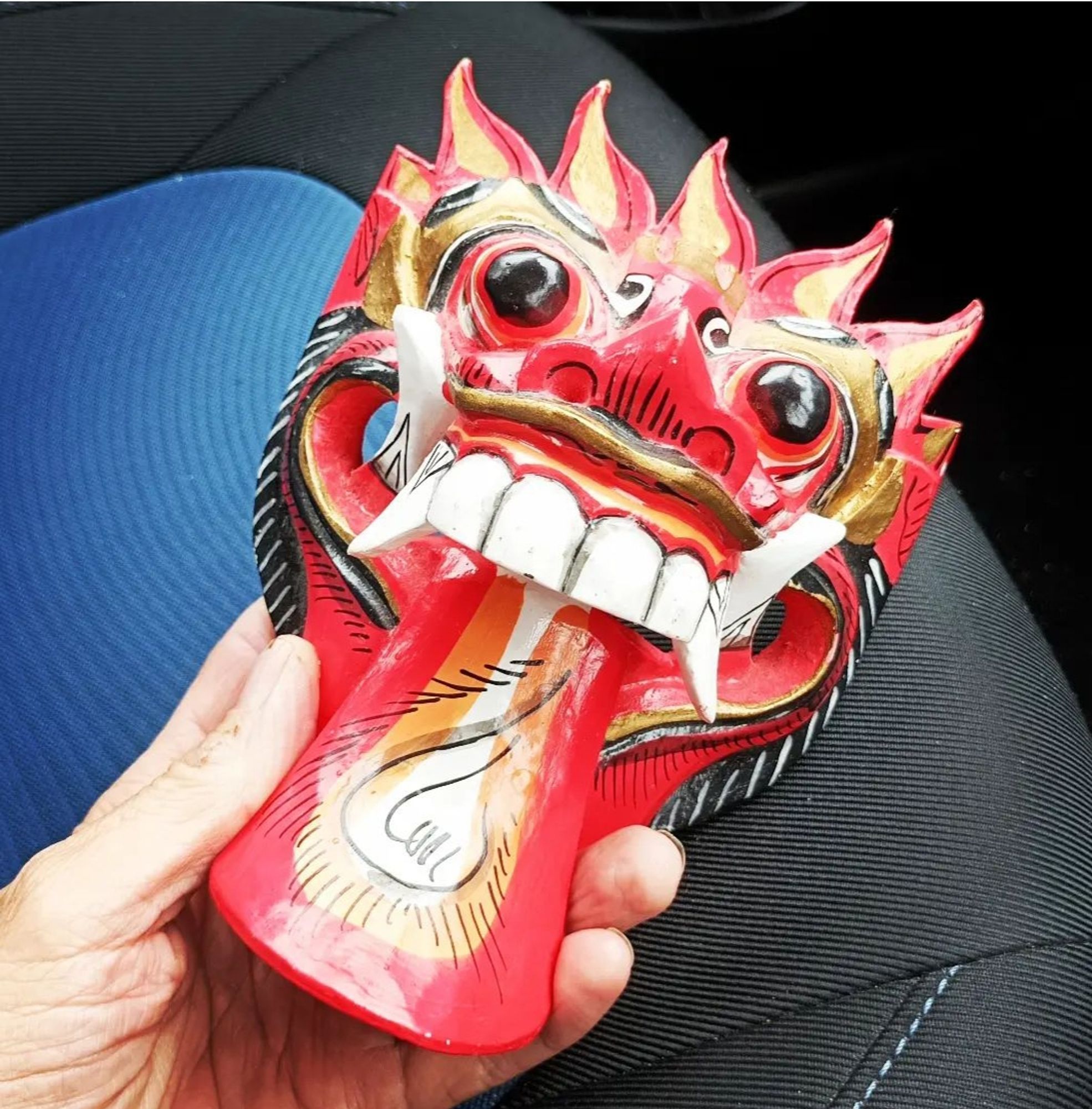 Carved, Red wooden voodoo ornament.