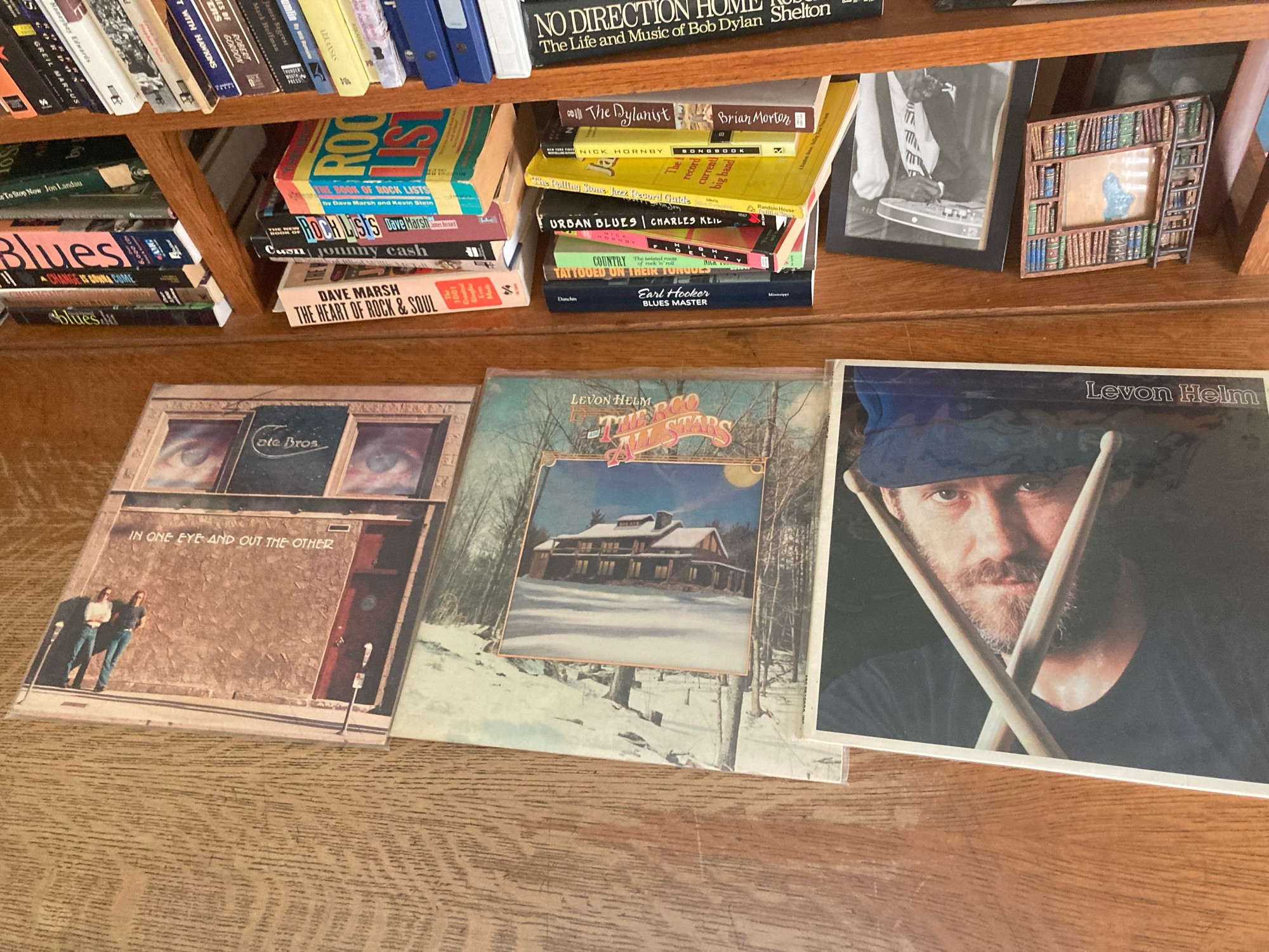 3 record album covers on a wooden desk top. There are lots of music-related books on the desk’s shelf above.
The Cate Brothers
Levon Helm & the RCO Allstars
Levon Helm (self-titled)