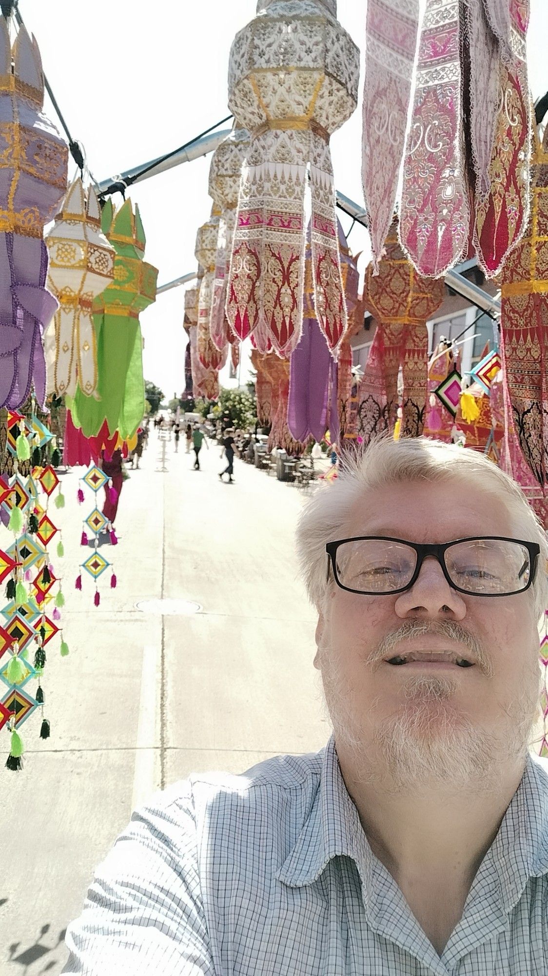 I'm trying a selfie in the welcome path-tent. Showing the street behind me.