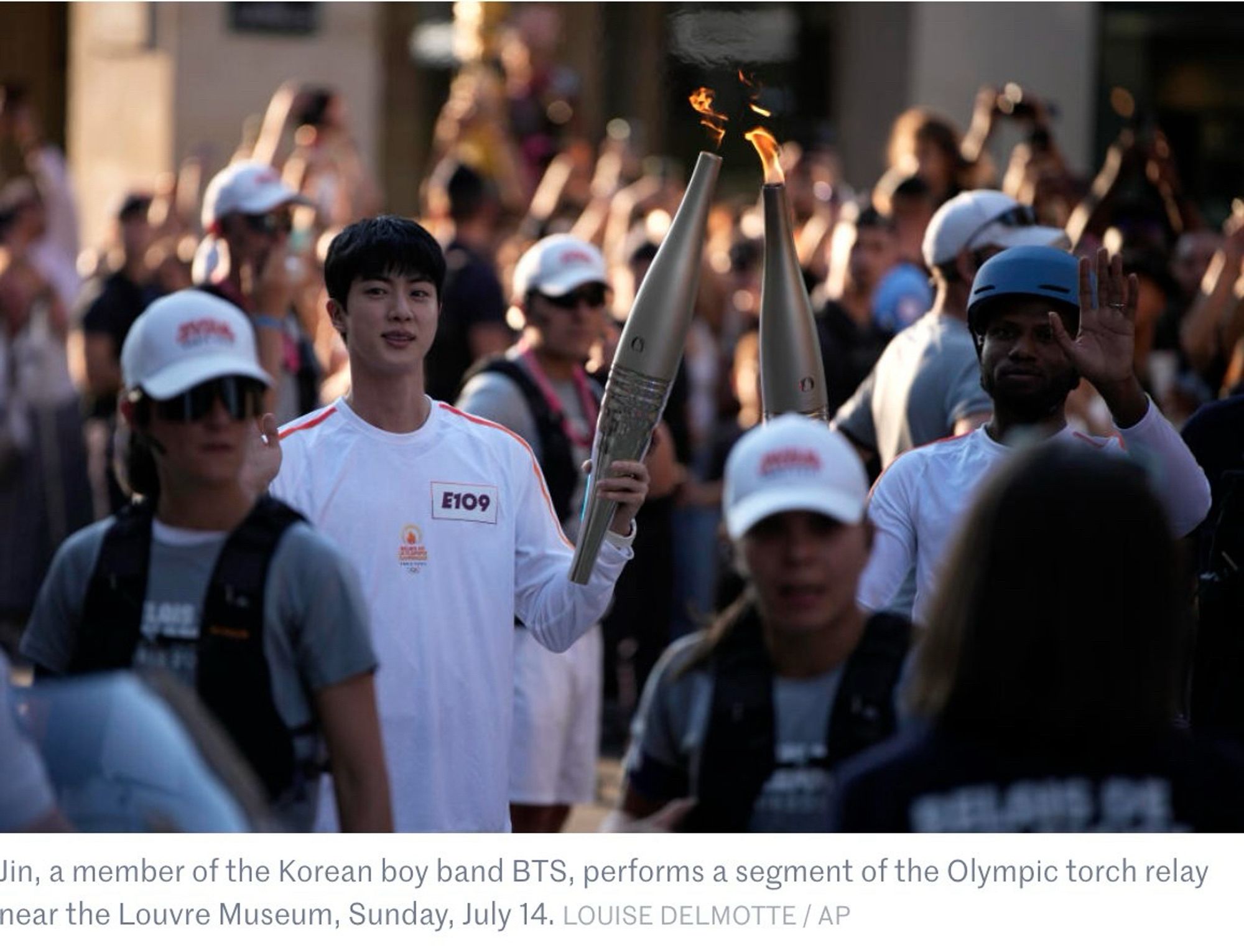 BTS Jin carrying the Olympic torch in Paris