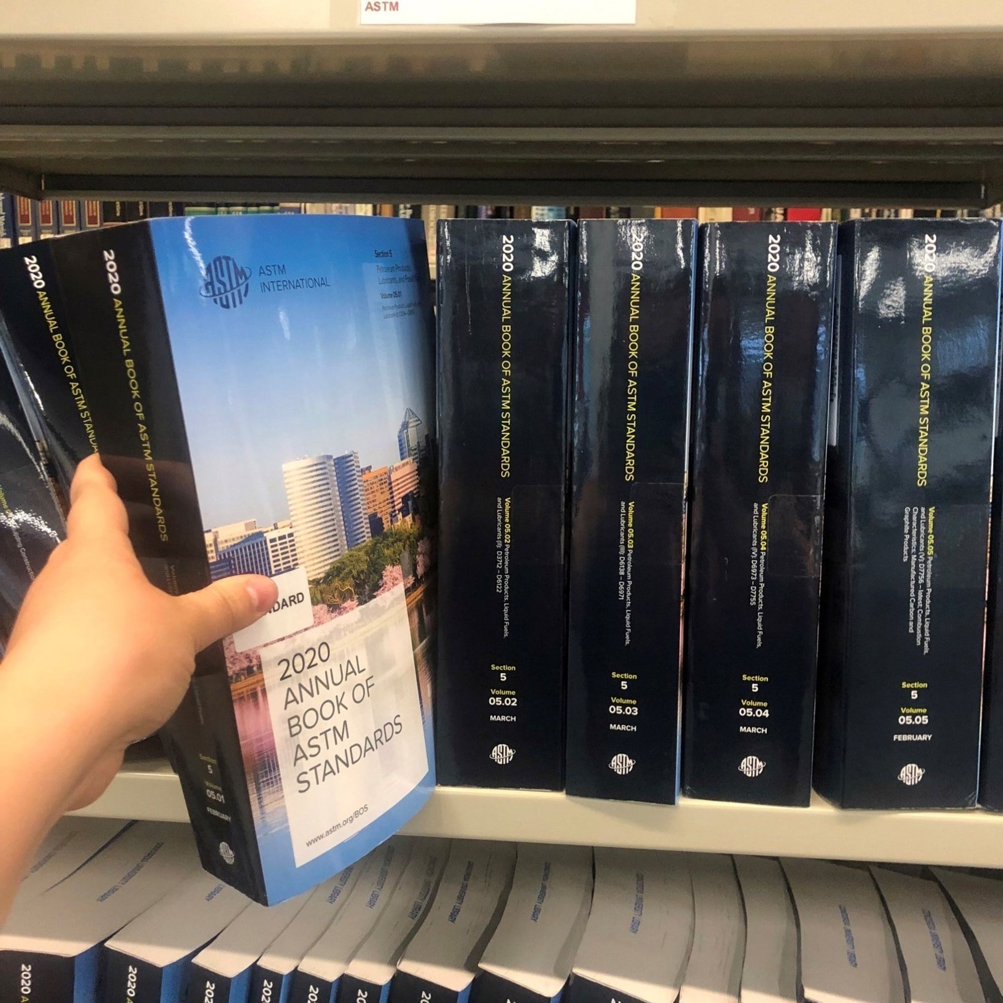 Photo I pinched from the web of a shelf of ASTM standards, because I forgot to take a picture of the similar shelves in the library. The books are all hefty paperbacks with black spines and the ASTM logo on the base.