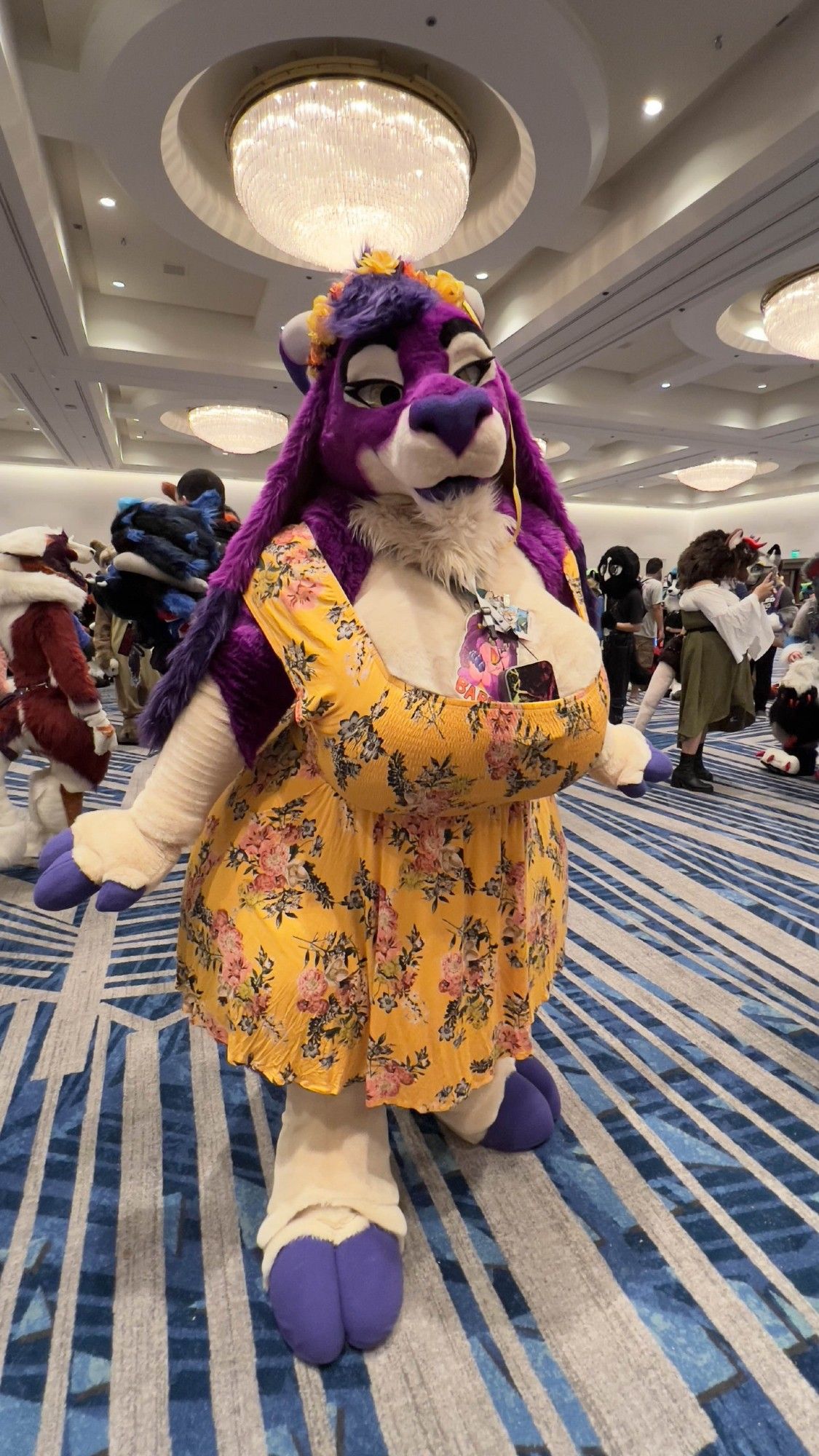 Purple goat fursuiter in a golden dress