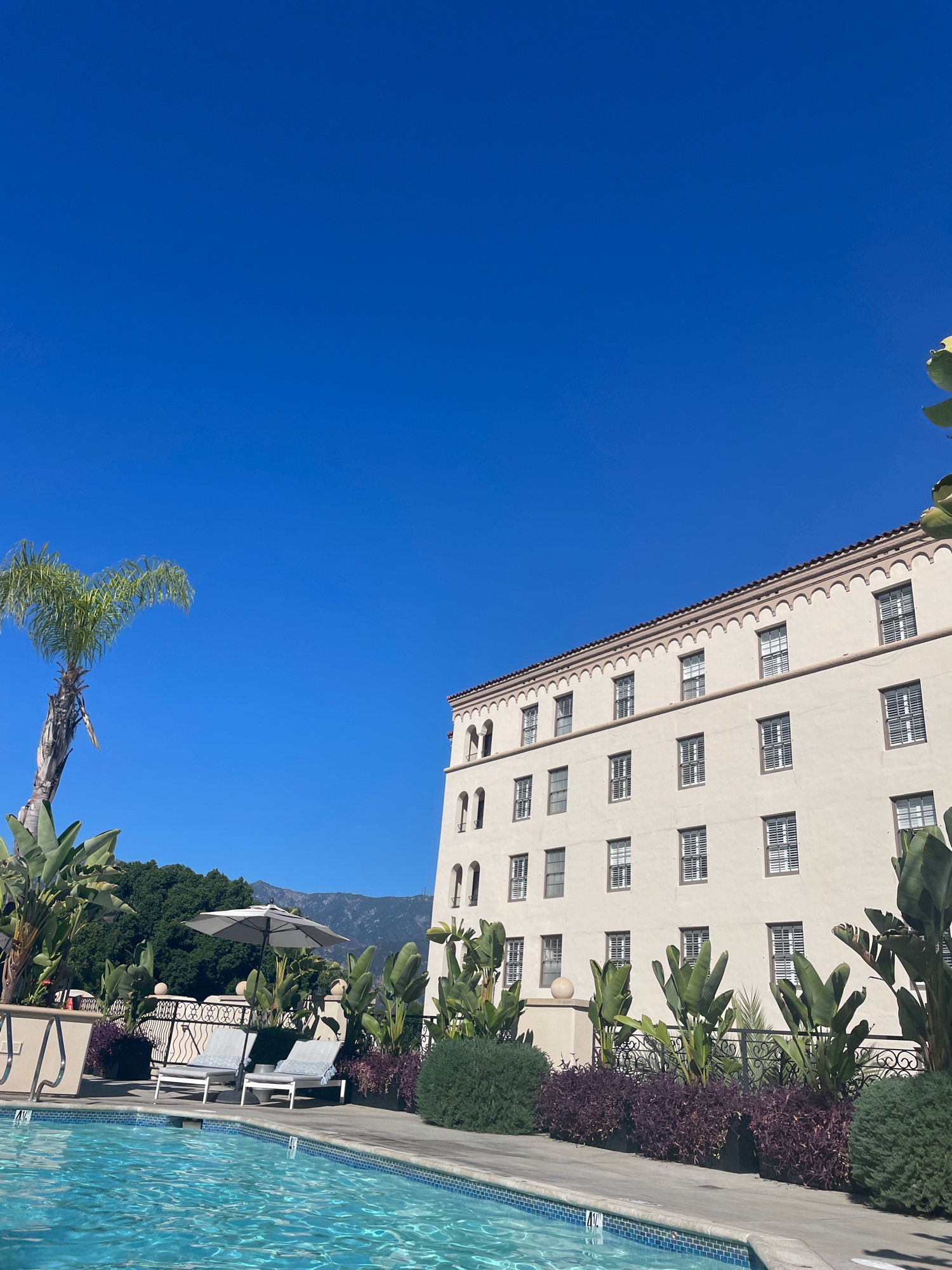 Swimming pool, hotel, San Bernadino mountains seen from Pasadena