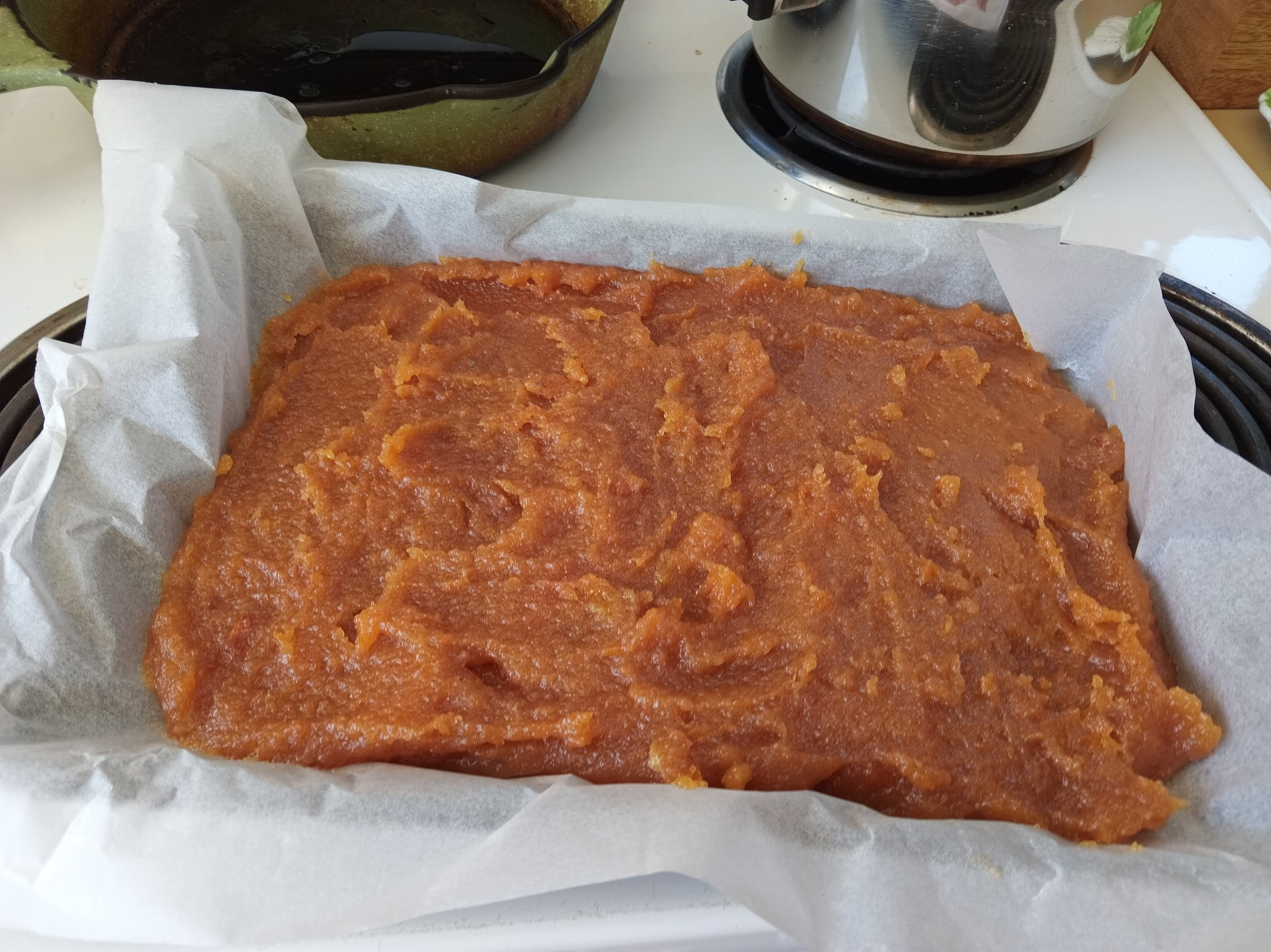 Finished amber coloured uince paste spread put in a baking tin.