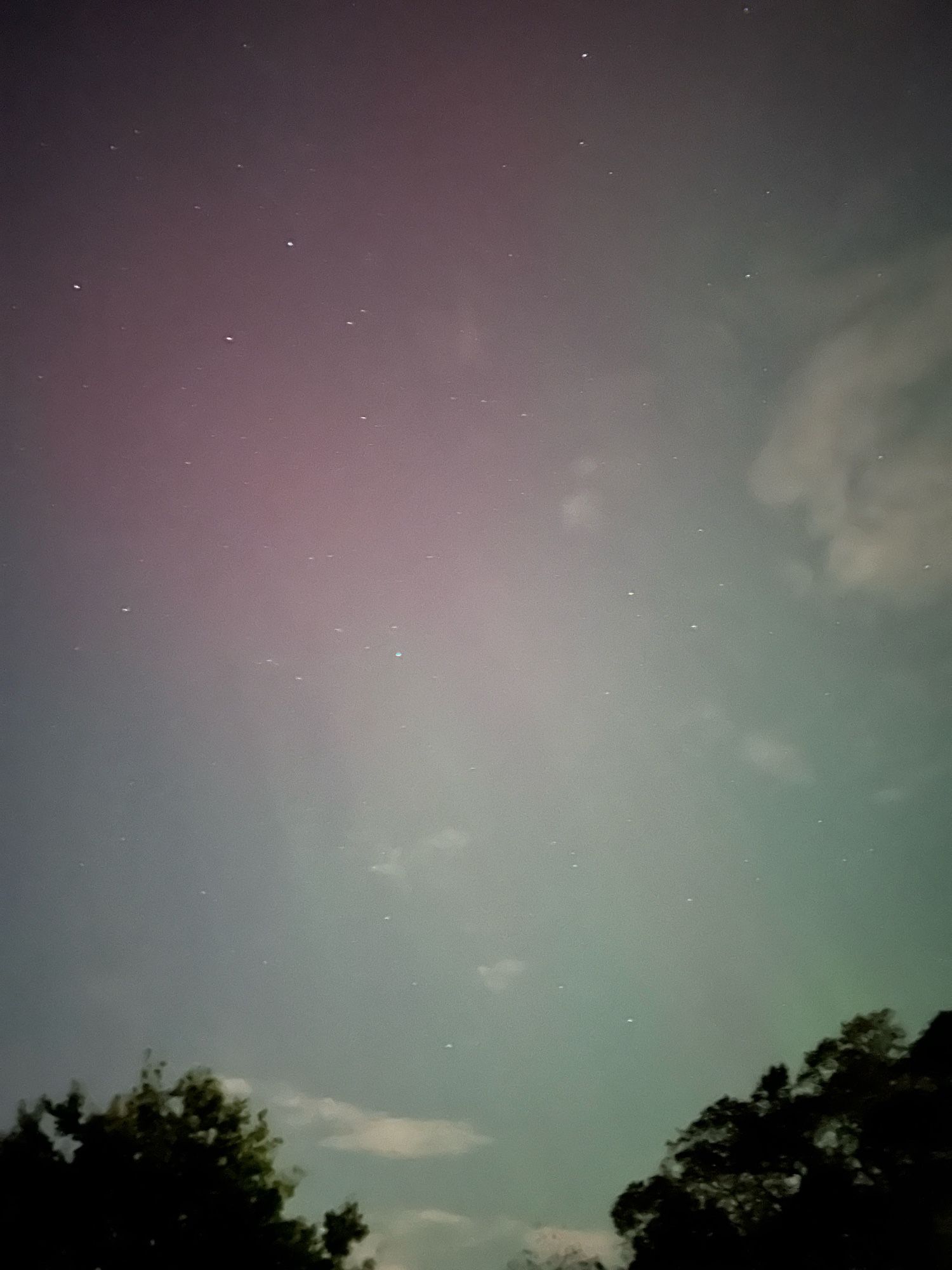 Faint Northern Lights pink and green shades and stars visible