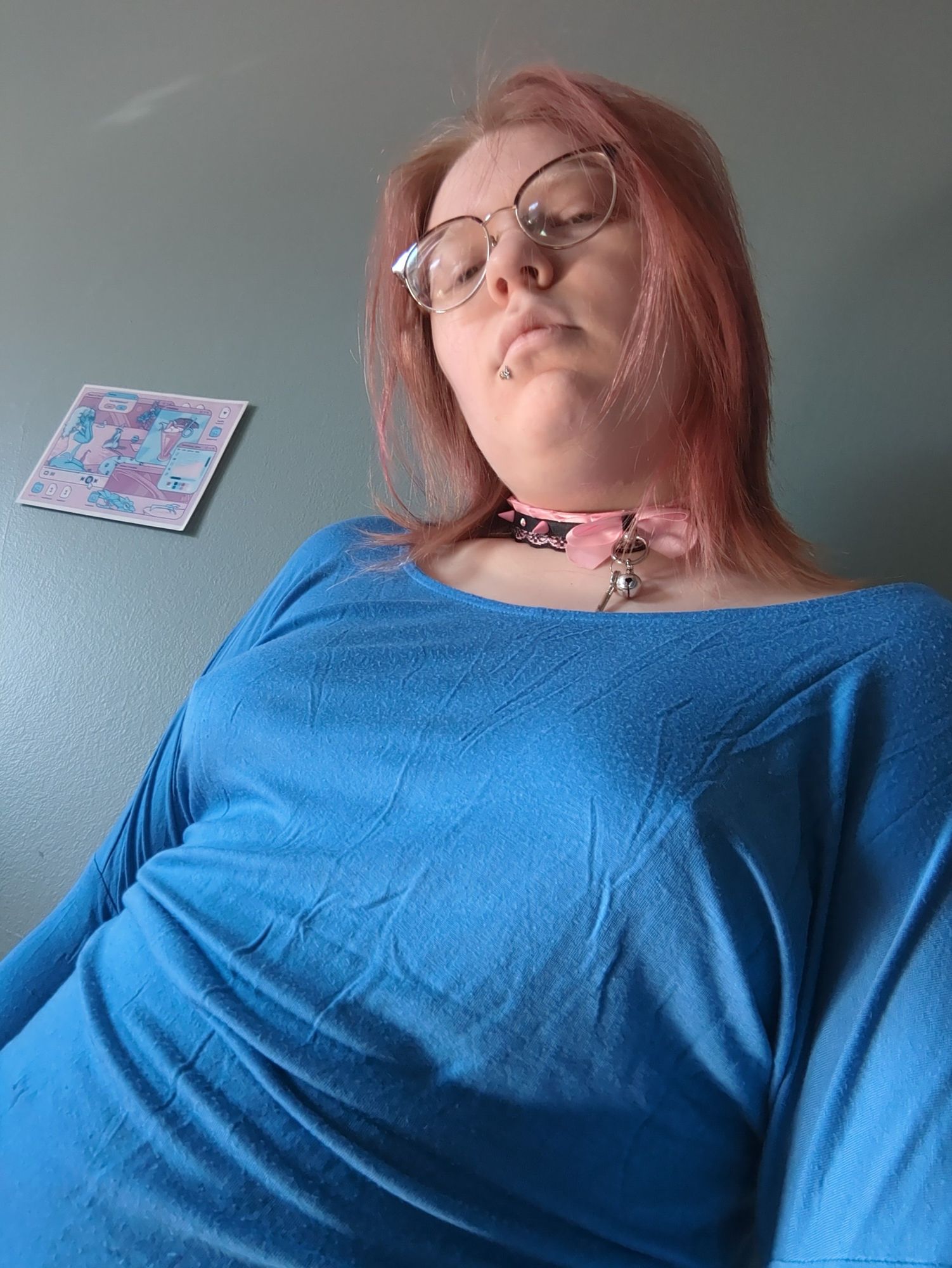 Many, from below, looking down at the viewer with a blue shirt on. The shirt is slightly thin, and you can clearly see the outline of faer hard nipples against it.