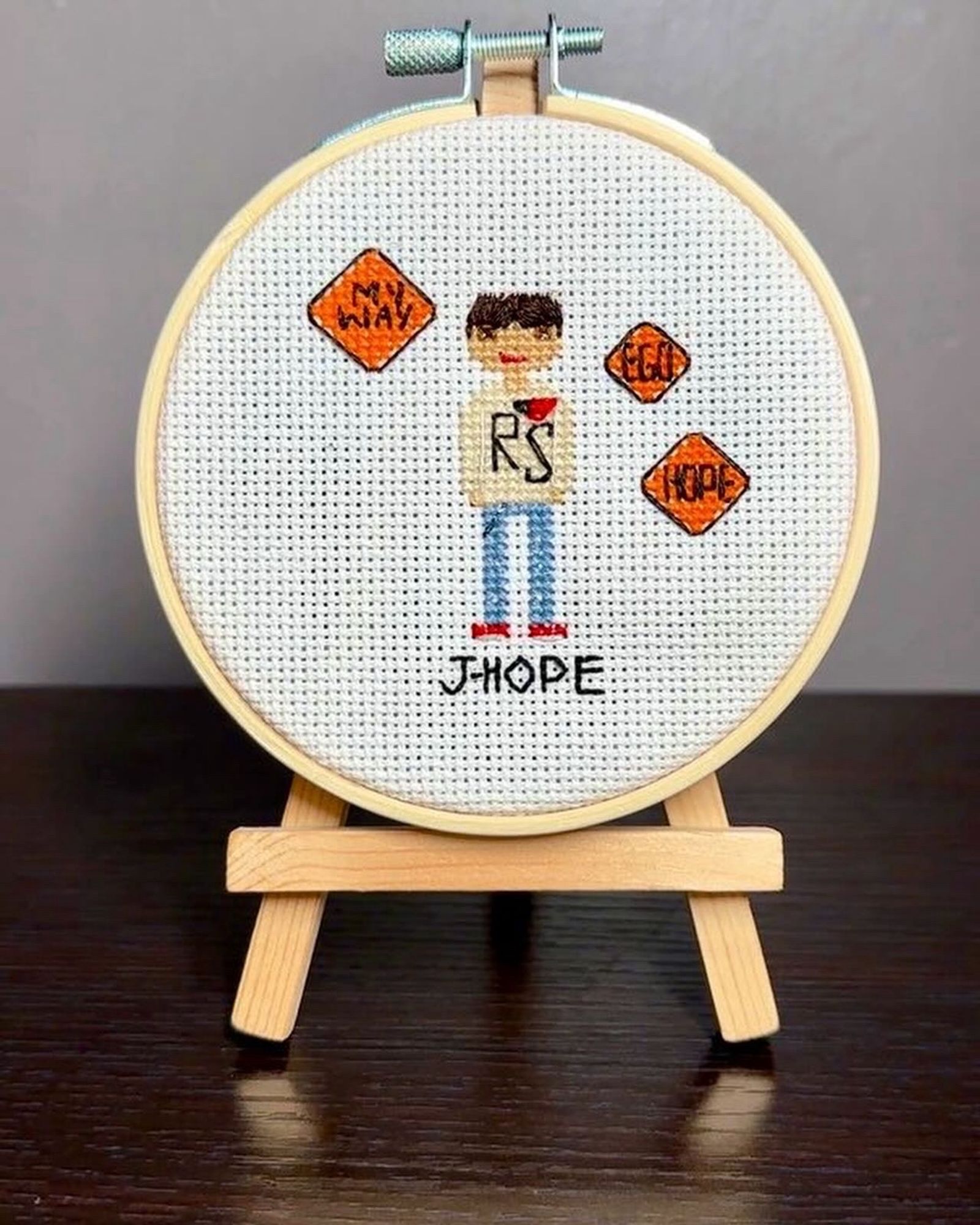 a cross stitch “person” of jhope inspired by his ego mv