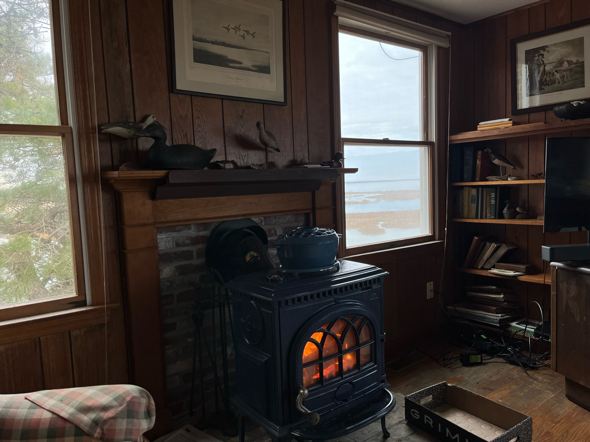 A wood burning stove warming the cabin overlooking the cape