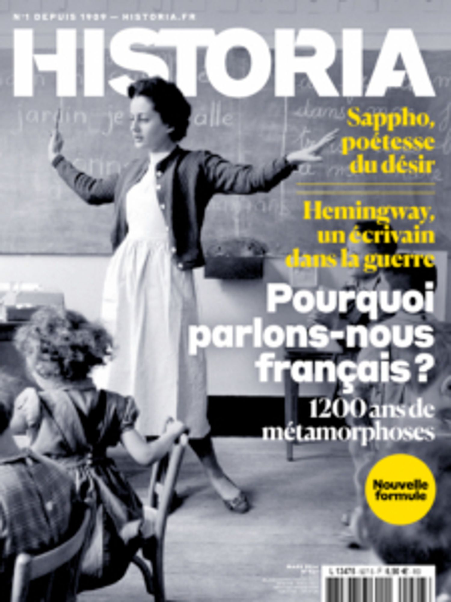 Couverture du numéro d'Historia daté du 1er mars 2024, "Pourquoi parlons-nous français ?". Photo en noir et blanc d'une institutrice donnant une leçon de français à ses élèves, un tableau noir à l'arrière-plan.