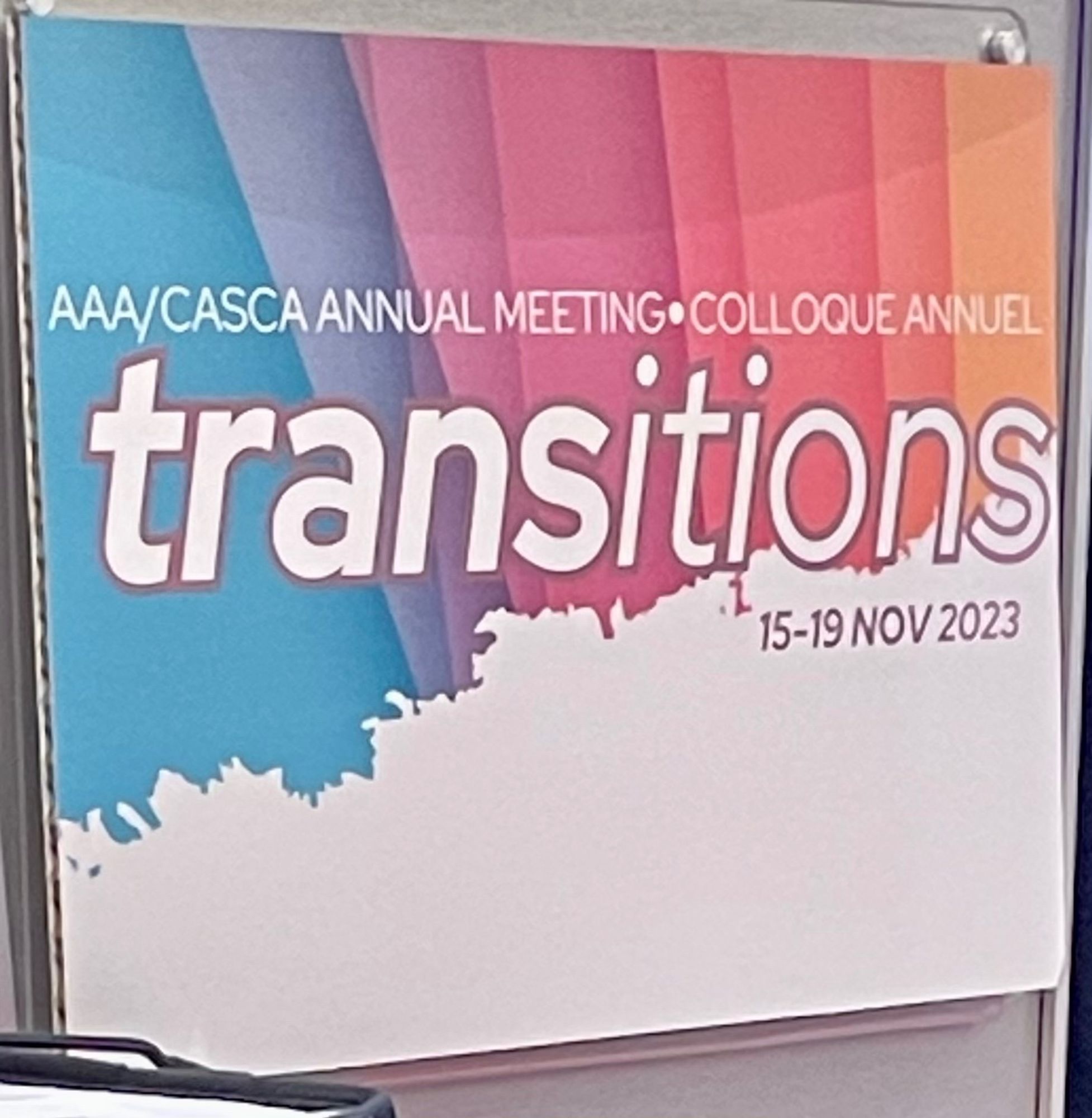 Meeting poster with the word transitions on a pastel rainbow background