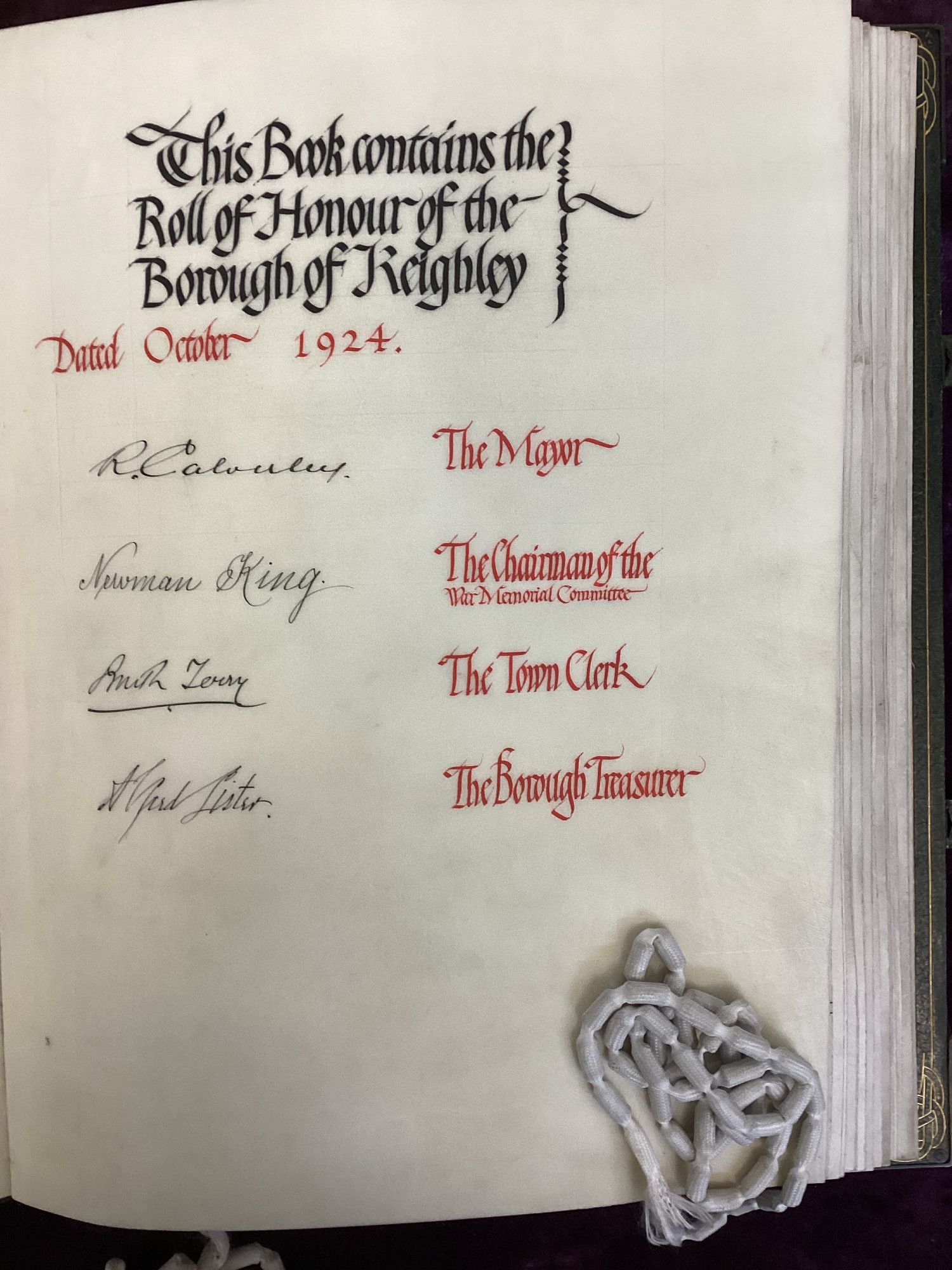 The signatories page in the Borough of Keighley Roll of Honour. This is a page of vellum, on which is written in red and black ink:
'The Book contains the Roll of Honour of the Borough of Keighley. Dated October 1924.'

R. Calverley - The Mayor.
Newman King - The Chairman of the War Memorial Committee.
Amith Terry - The Town Clerk.
Alfred Lister - The Borough Treasurer.