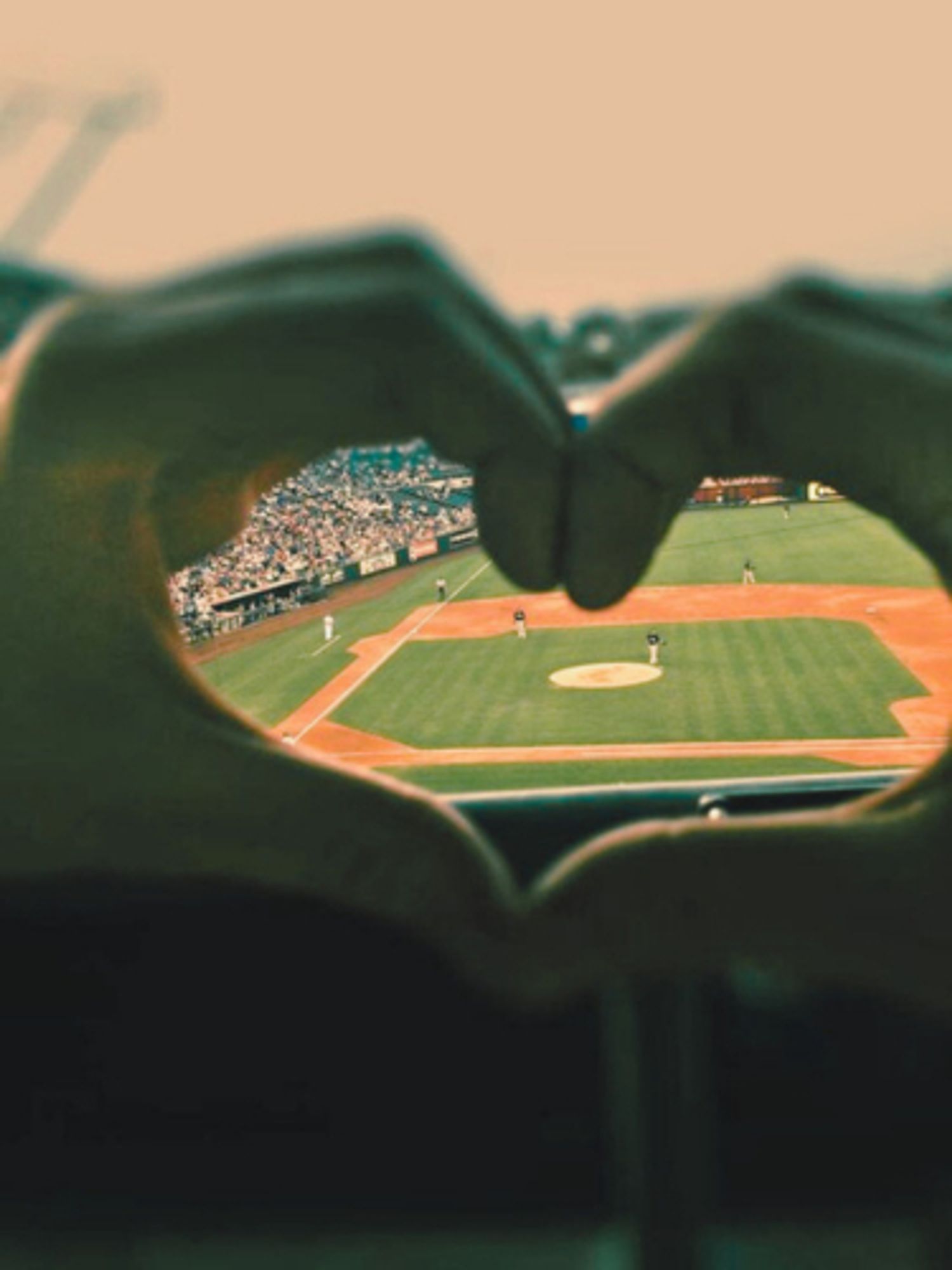 picture of two hands making a heart. within the shape of the heart, a baseball field is visible. the picture was shamelessly stolen from pinterest.