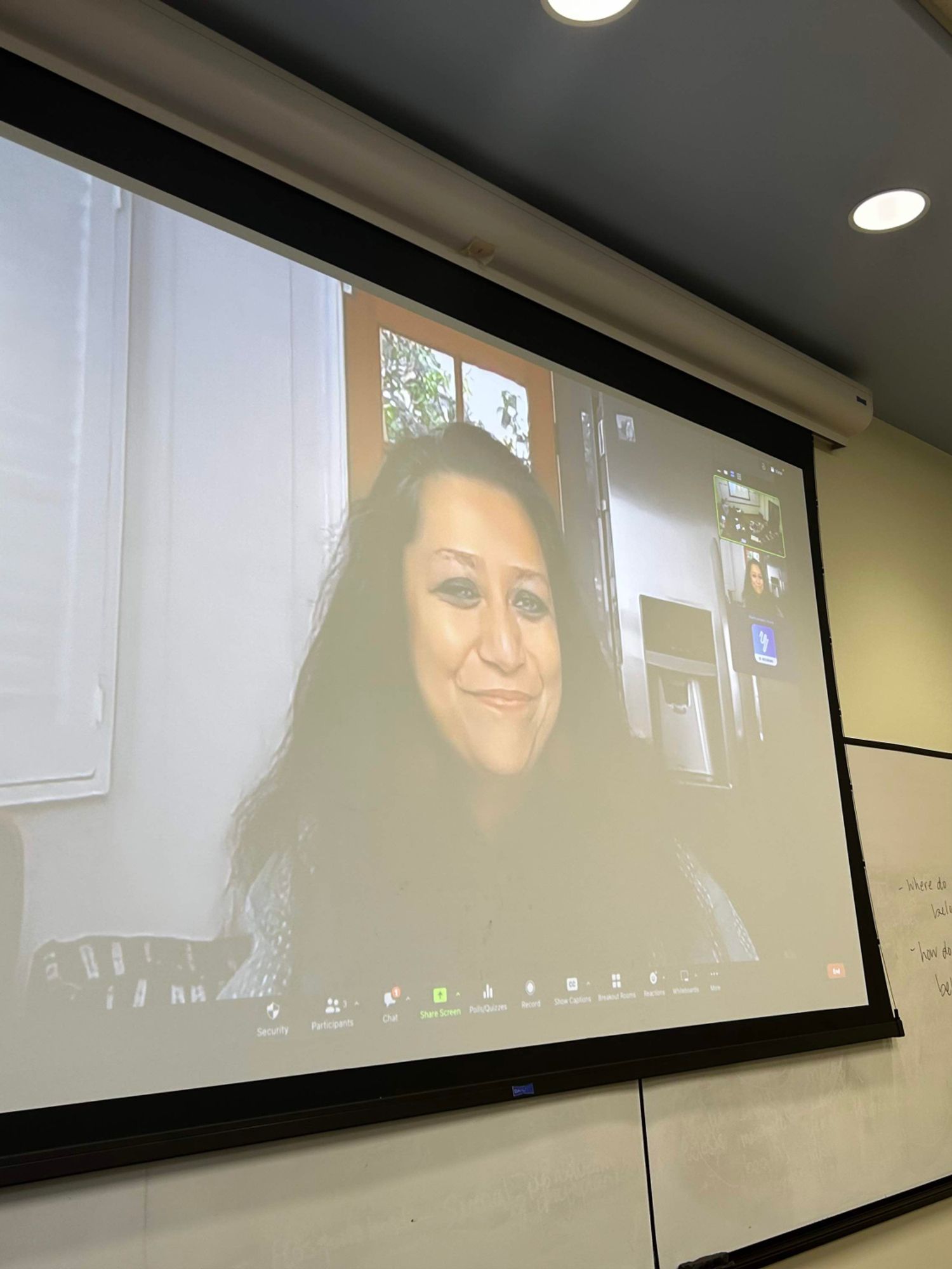 M. Ghosh on a projection screen, in classroom via Zoom.