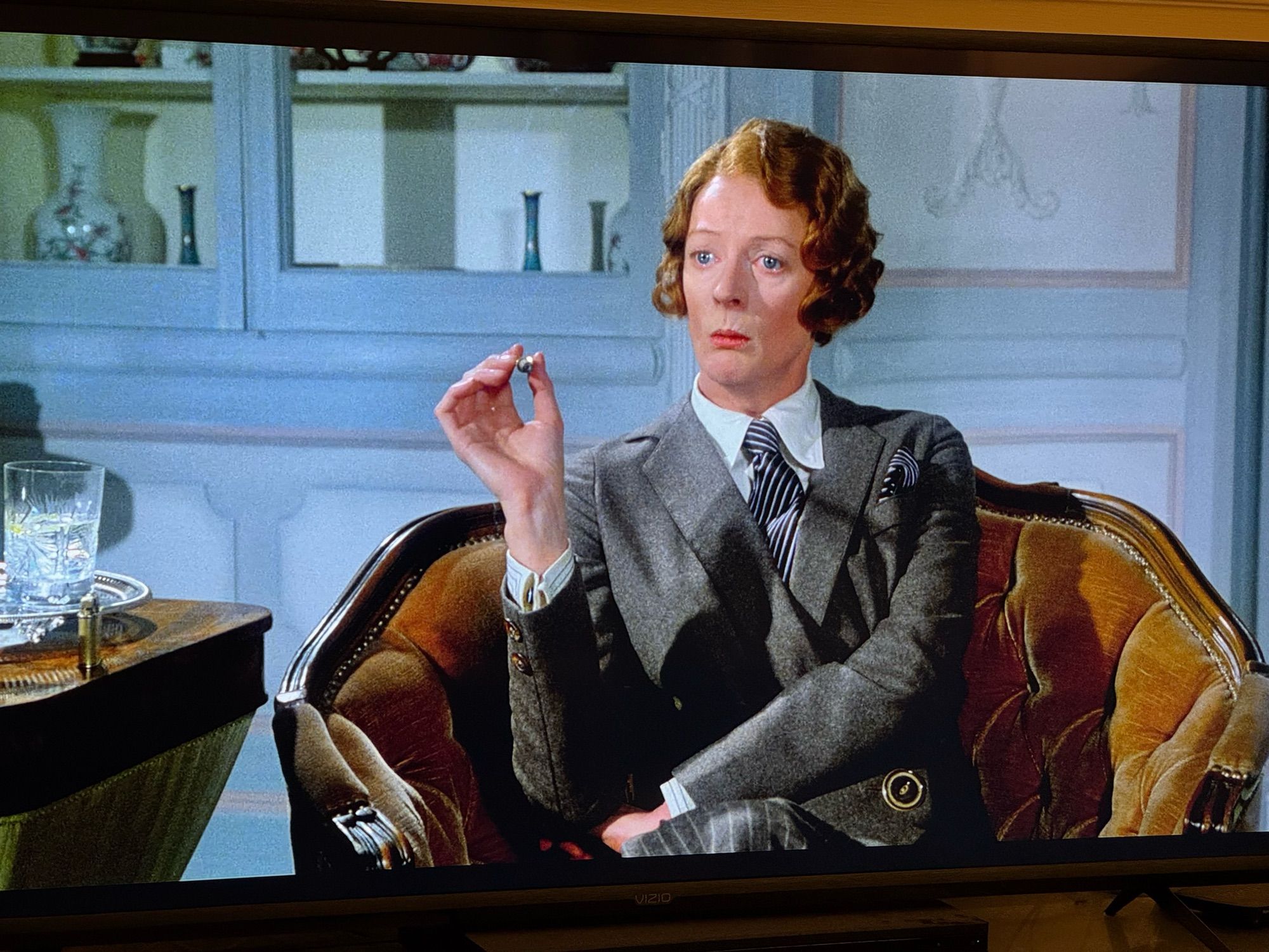 Maggie Smith in _Death On The Nile_ in a 30s haircut, a masculine suit top, a precisely held cigarette and the vibe of “Do not even try and fuck with me.”