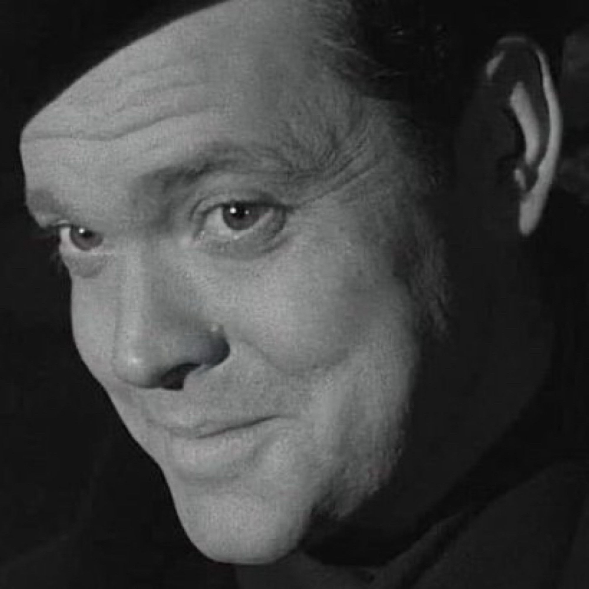 Orson Welles looking into the camera with a devilish smile