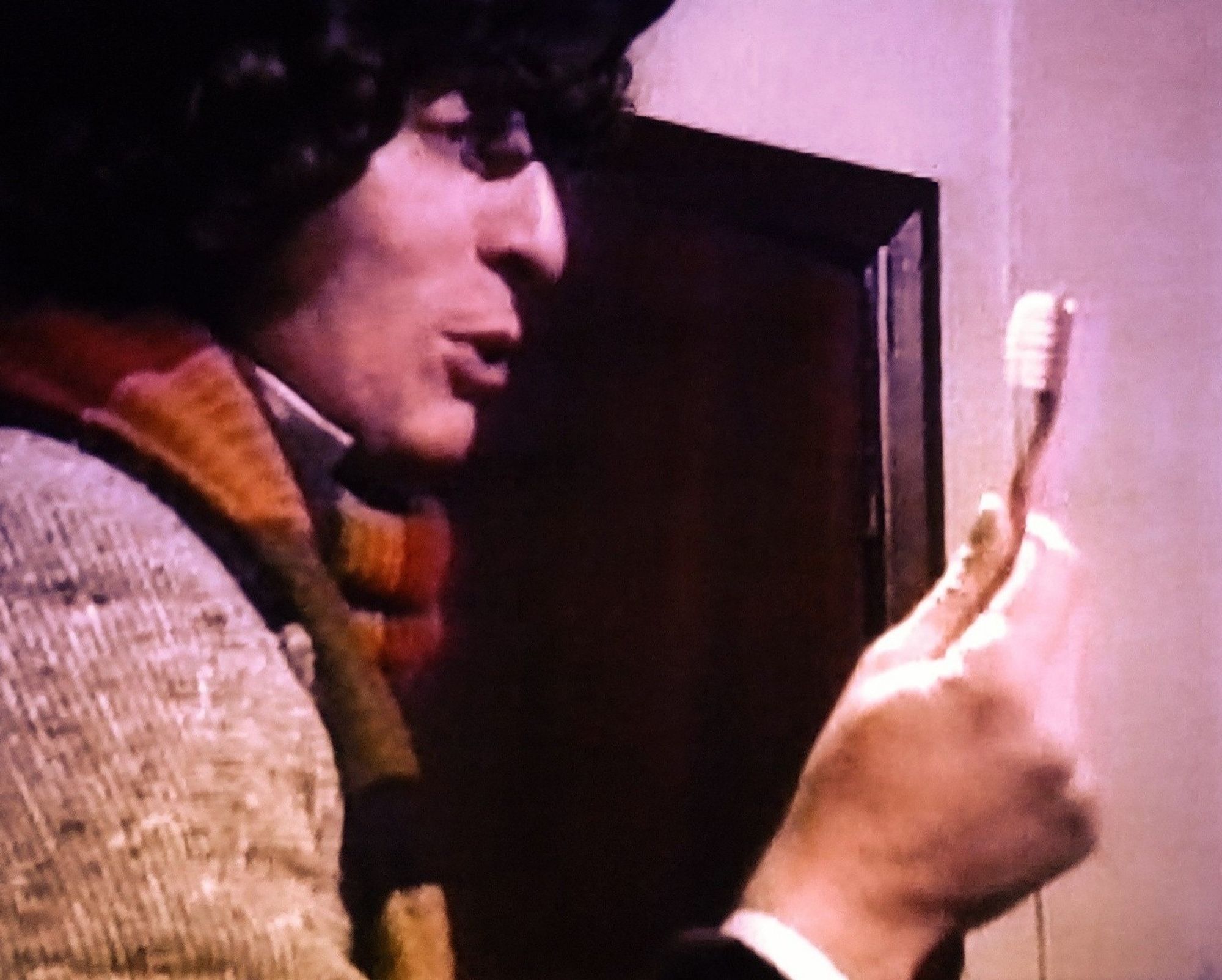 Still of Tom Baker holding a toothbrush in Seeds of Doom.